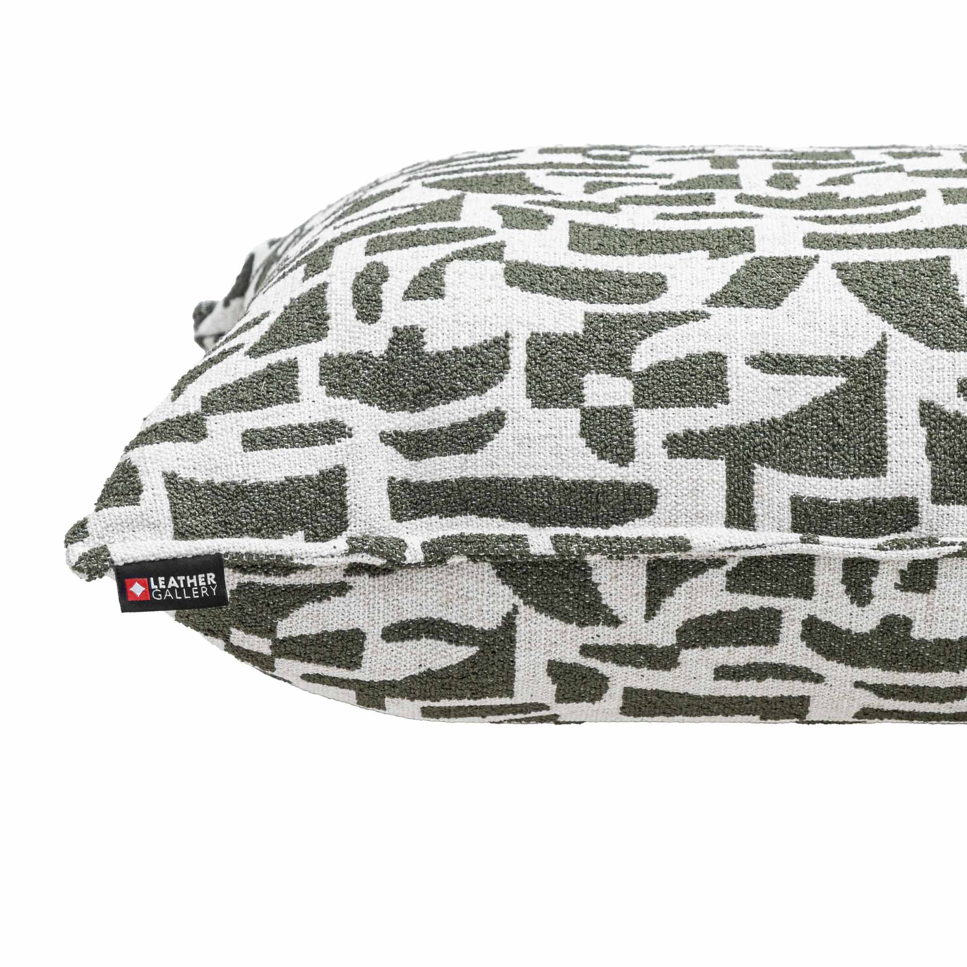 Leather Gallery Krait Cushion in Mediterranean Olive, featuring a geometric woven pattern and branded Leather Gallery tag.