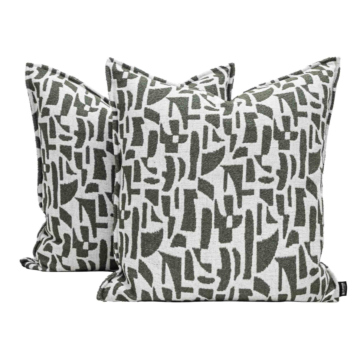 Two Leather Gallery Krait Cushions in Mediterranean Olive, featuring an abstract geometric pattern on an off-white background.