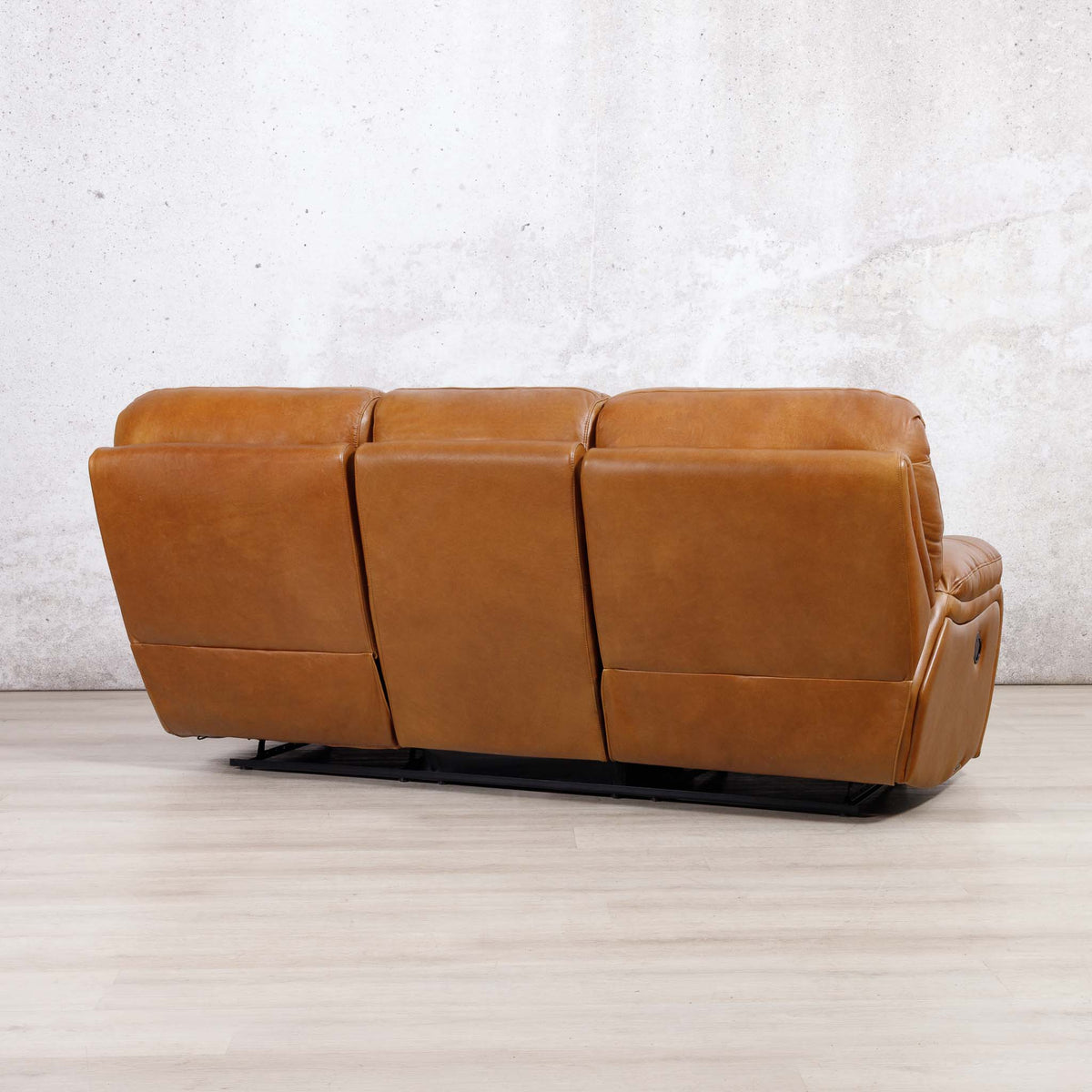 Low-angle view of the Leather Gallery Kuta 3 Seater Leather Recliner in Czar Pecan, showing its smooth leather upholstery and power reclining design.