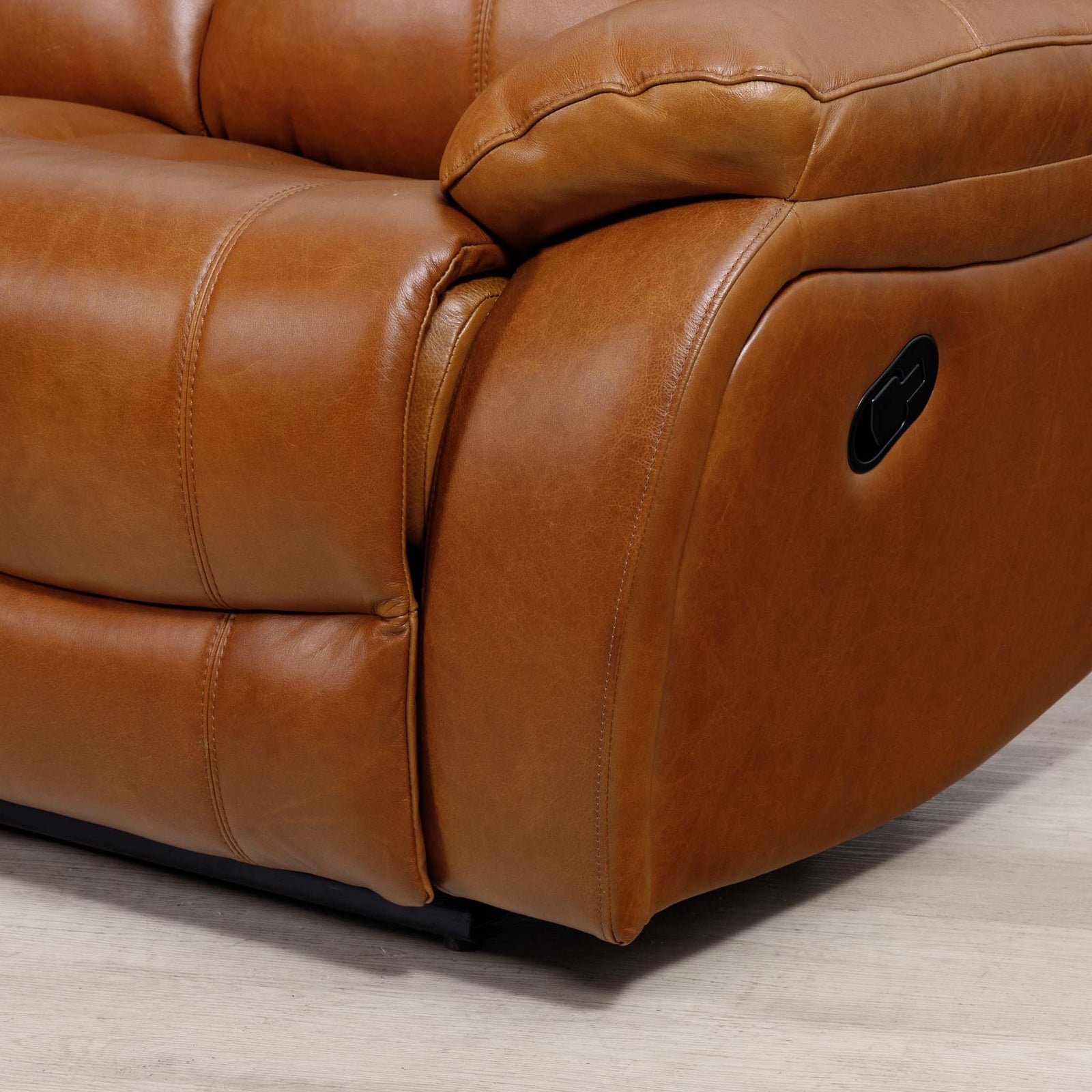 Close-up of the Leather Gallery Kuta 1 Seater Leather Recliner in Czar Pecan, showing the side armrest, stitching, and black control panel.