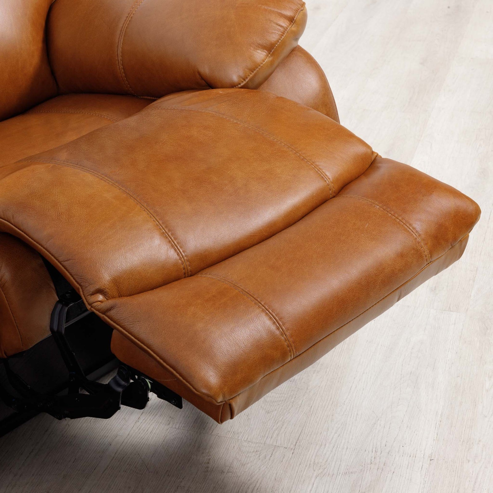Close-up of the Leather Gallery Kuta 2 Seater Leather Recliner Home Theatre in Czar Pecan, showing the extended footrest and padded armrest.