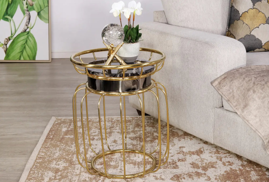 Add functional elegance to your space with the Eve Side Table, designed with a lifted rim, gold stainless-steel base, and black marble look top.