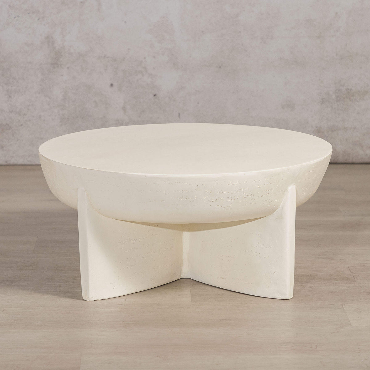 Gallery Everyday Lille Coffee Table in Pale Parchment, featuring a round concrete top and sculptural pedestal base in a bright modern living room.