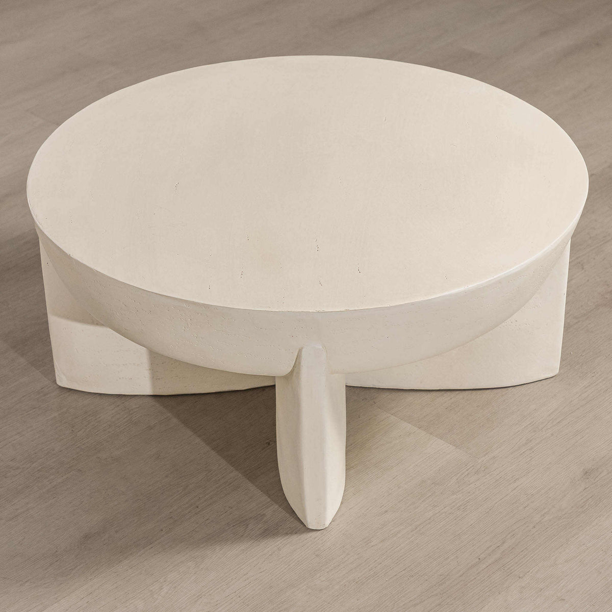 Gallery Everyday Lille Coffee Table in Pale Parchment, featuring a round concrete top and sculptural pedestal base in a bright modern living room.