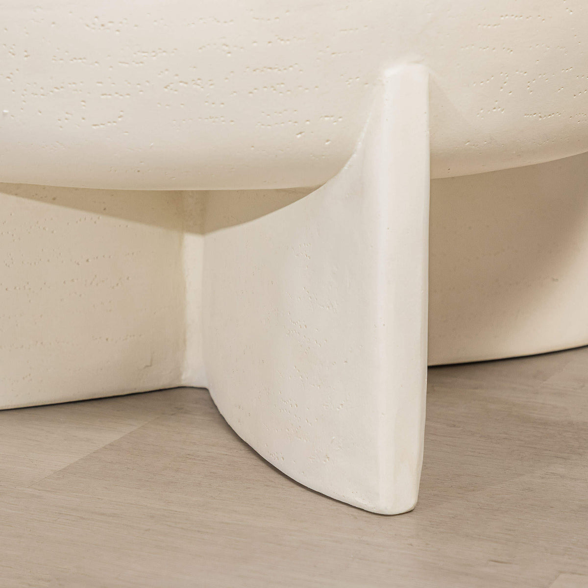 Gallery Everyday Lille Coffee Table in Pale Parchment, featuring a round concrete top and sculptural pedestal base in a bright modern living room.