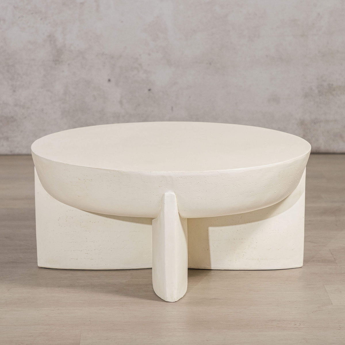 Gallery Everyday Lille Coffee Table in Pale Parchment, featuring a round concrete top and sculptural pedestal base in a bright modern living room.