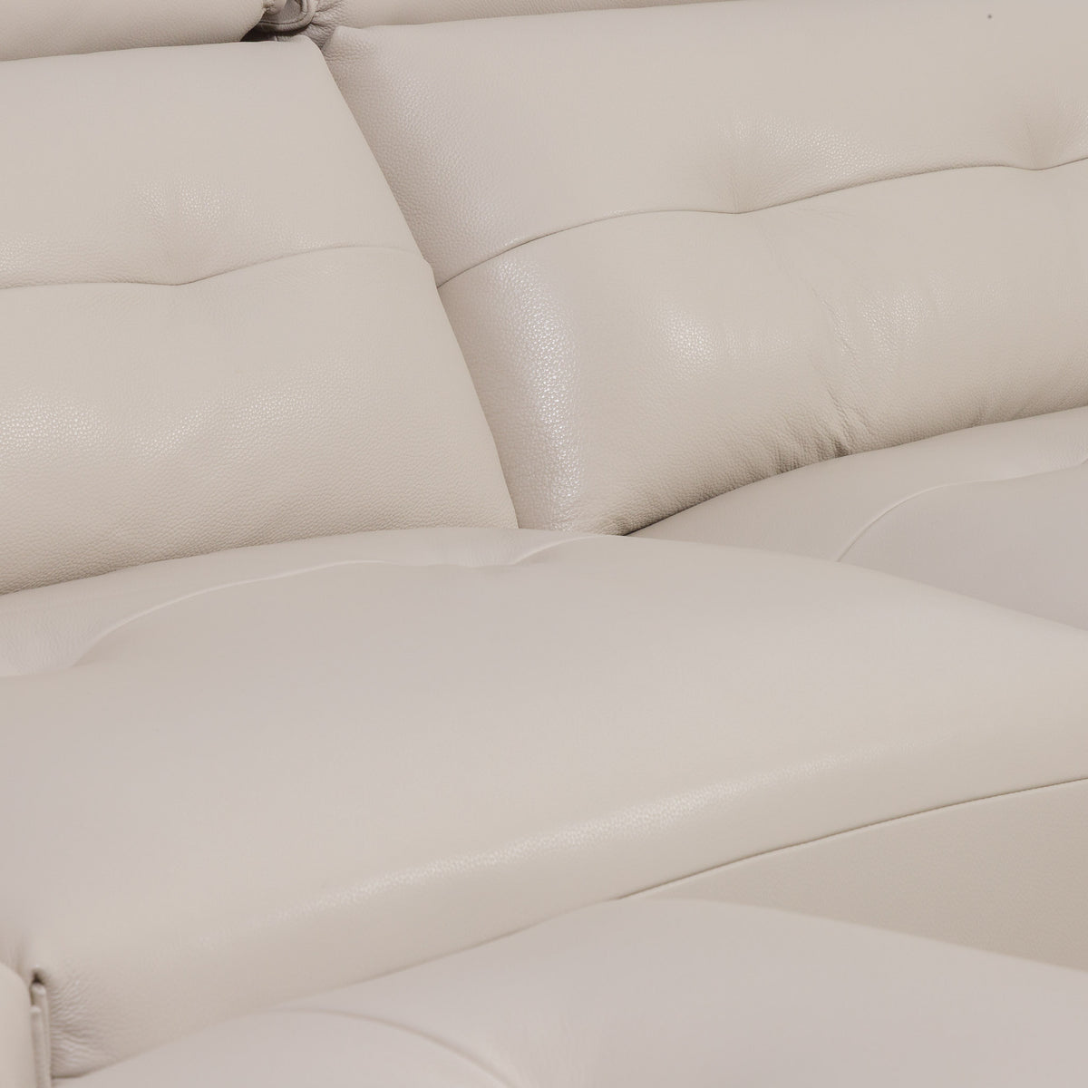 Close-up of the Leather Gallery Marbella 5 Seater Leather L Shape Couch in Cream Beige, showing tufted back cushions and smooth leather upholstery.