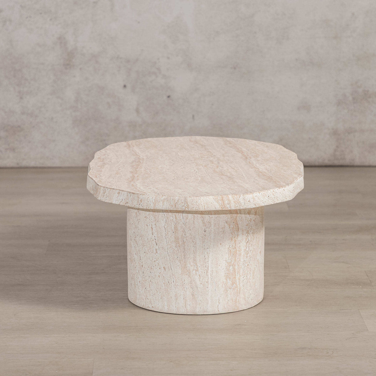 Gallery Everyday Marea Coffee Table in Seashell, featuring a round stone design with a warm beige travertine-look finish.