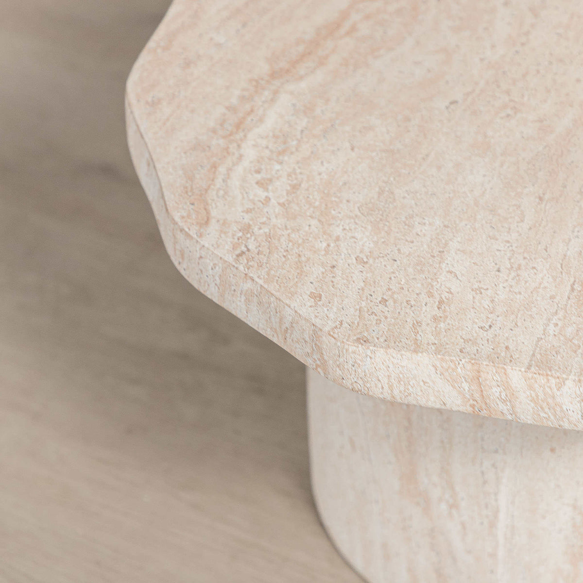Gallery Everyday Marea Coffee Table in Seashell, featuring a round stone design with a warm beige travertine-look finish.