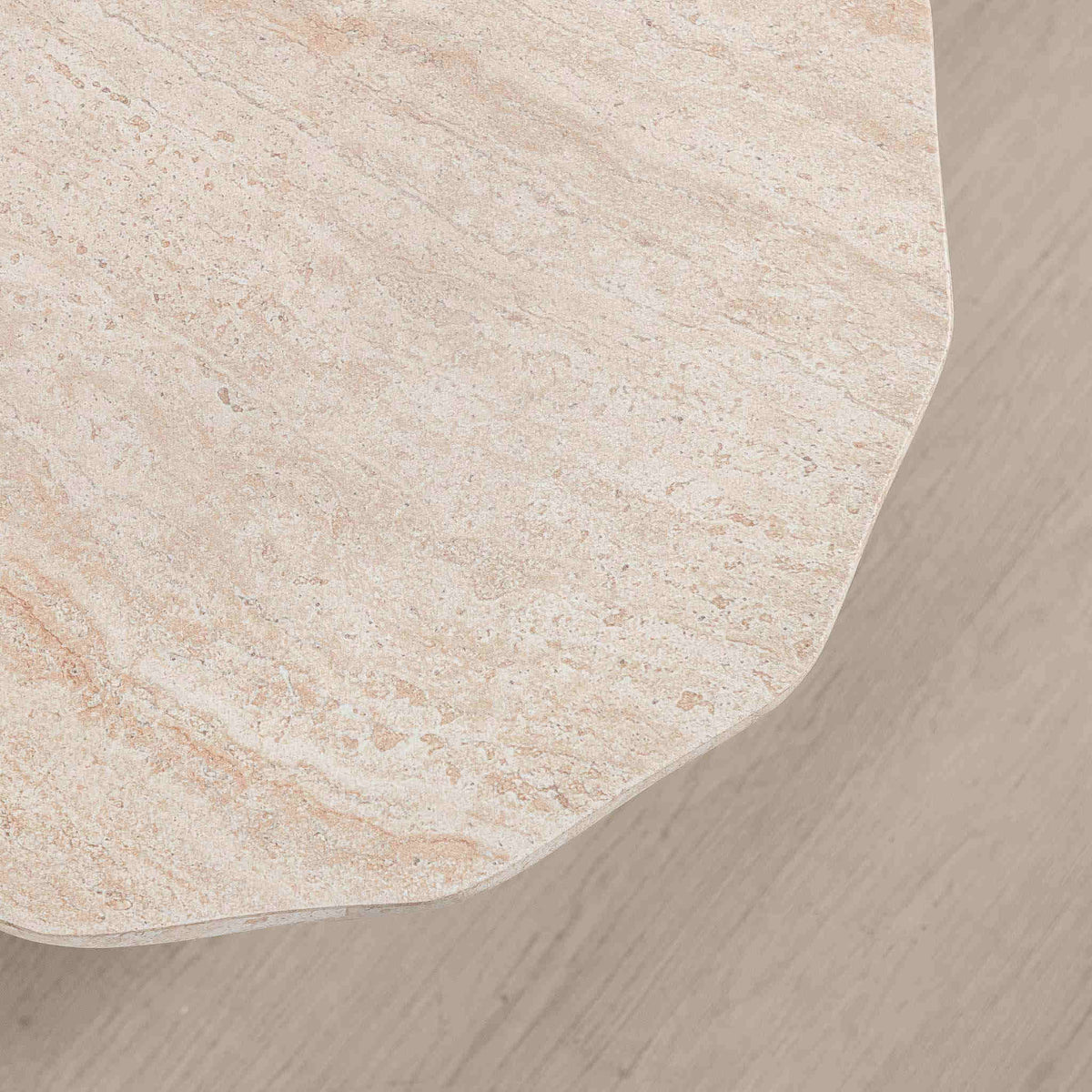 Gallery Everyday Marea Coffee Table in Seashell, featuring a round stone design with a warm beige travertine-look finish.