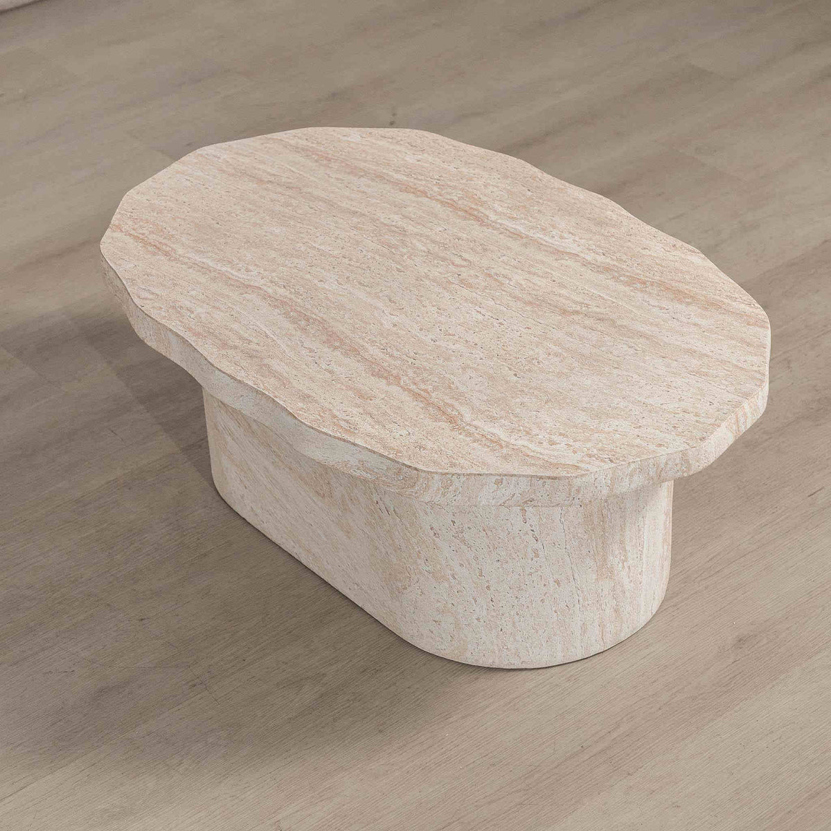 Gallery Everyday Marea Coffee Table in Seashell, featuring a round stone design with a warm beige travertine-look finish.
