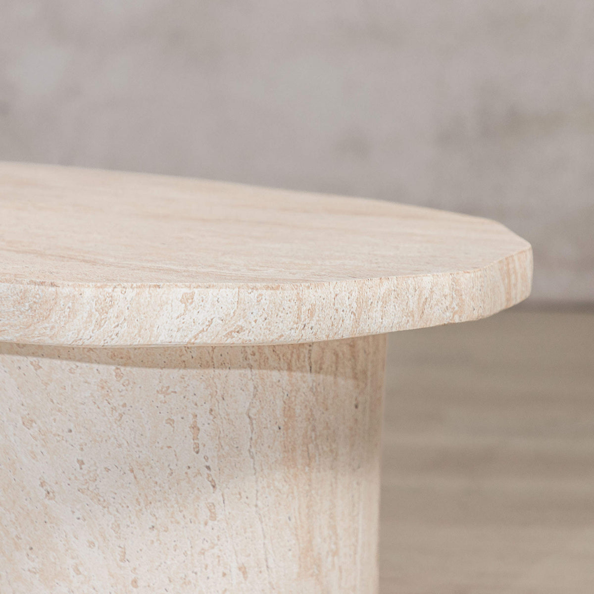 Gallery Everyday Marea Coffee Table in Seashell, featuring a round stone design with a warm beige travertine-look finish.