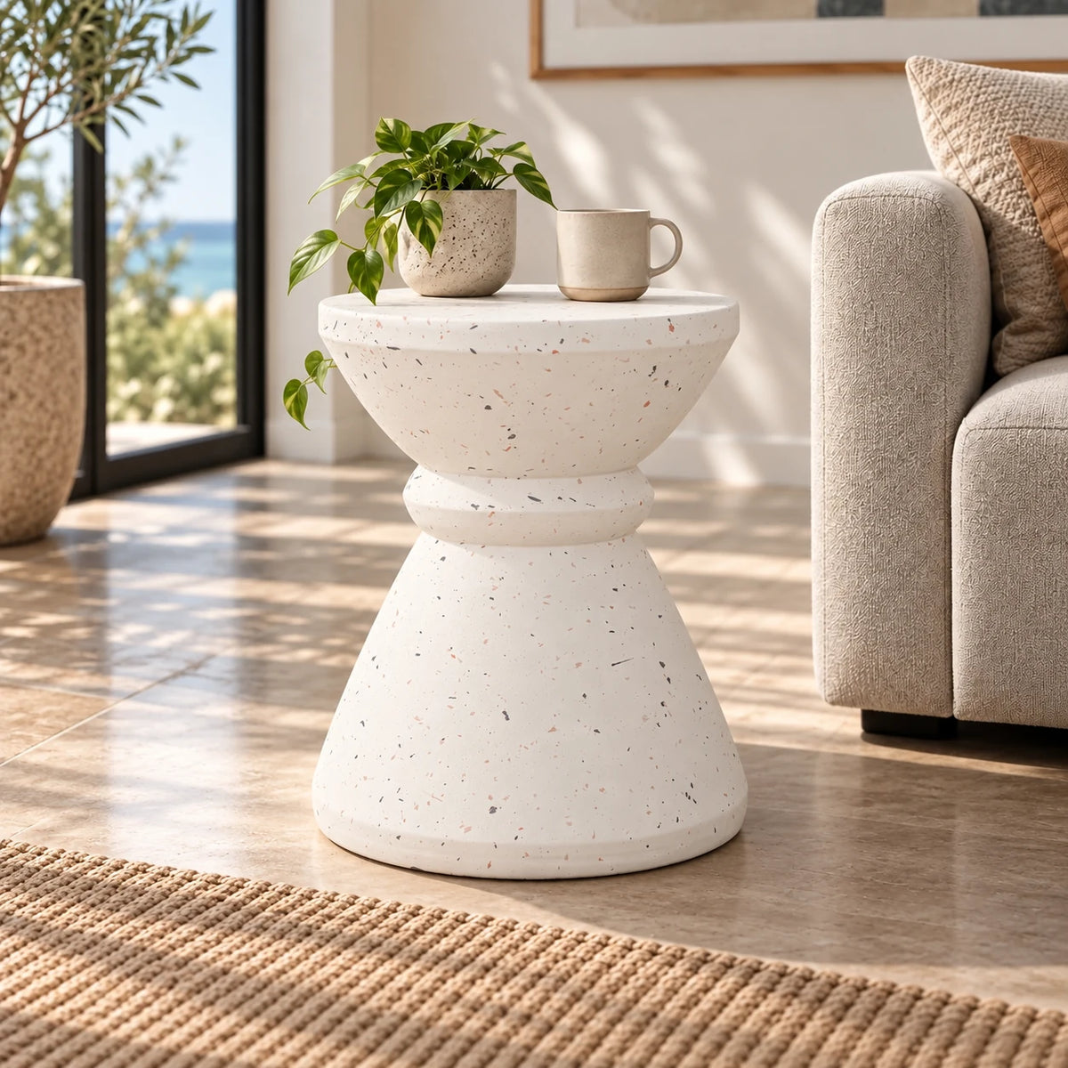 Gallery Everyday Marielle Side Table in Stone, featuring a round concrete design with a speckled beige finish.