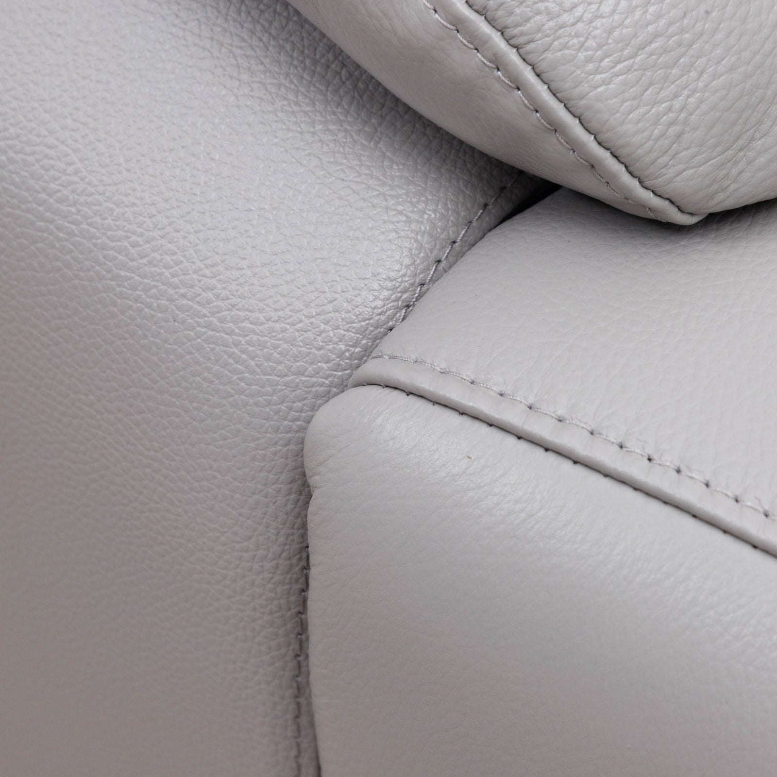 Close-up of the Leather Gallery Marino 3 Seater Leather Recliner in Luxe Grey, showing pebbled leather, visible stitching, and cushion detail.