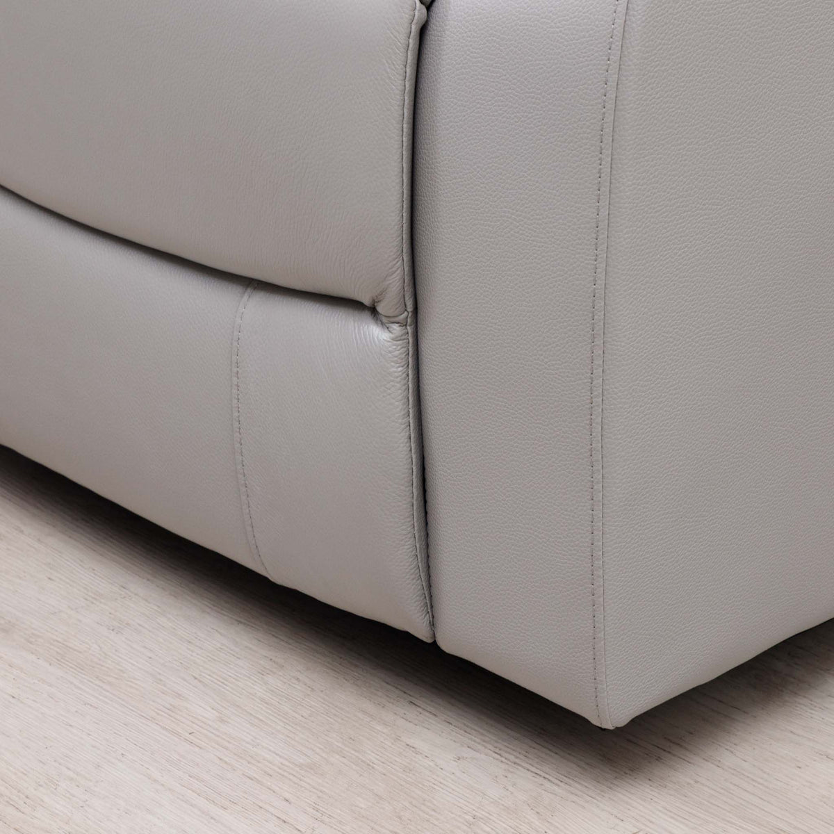 Close-up of the Leather Gallery Marino 3 Seater Leather Recliner in Luxe Grey, showing the upholstered corner and visible stitching.