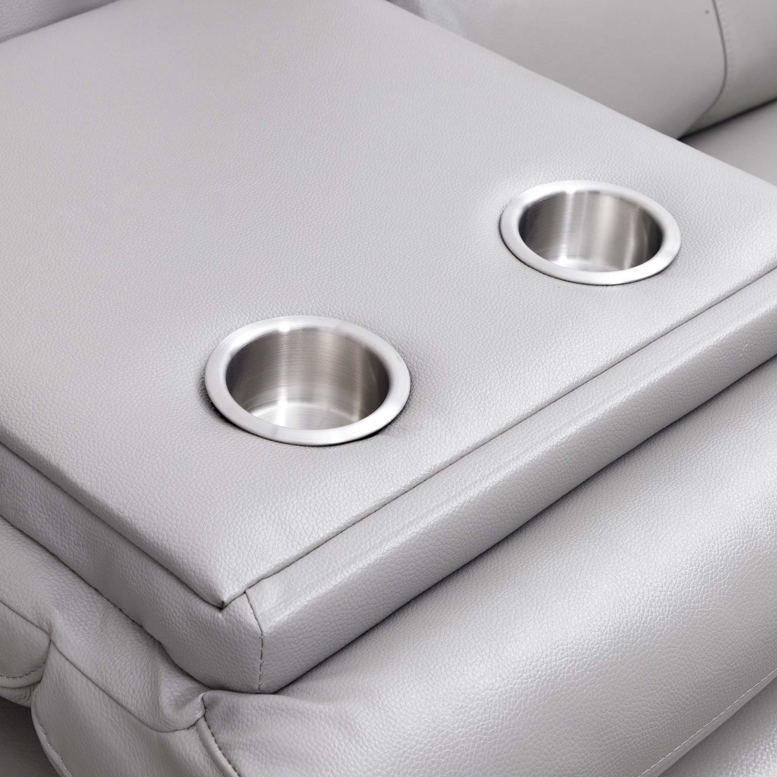 Close-up of the Leather Gallery Marino 3 Seater Leather Recliner in Luxe Grey, showing two stainless steel cup holders in the centre console.