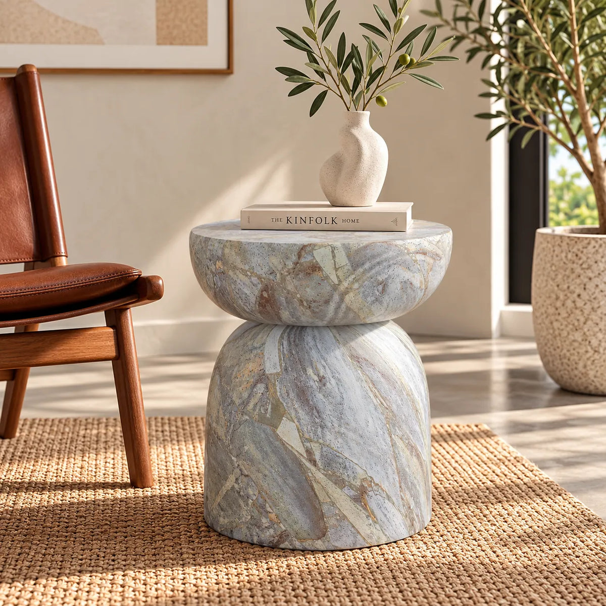 Gallery Everyday Ostia Side Table in Aqua Mist, featuring a round stone top and sculptural pedestal base with a blue-grey and cream finish.