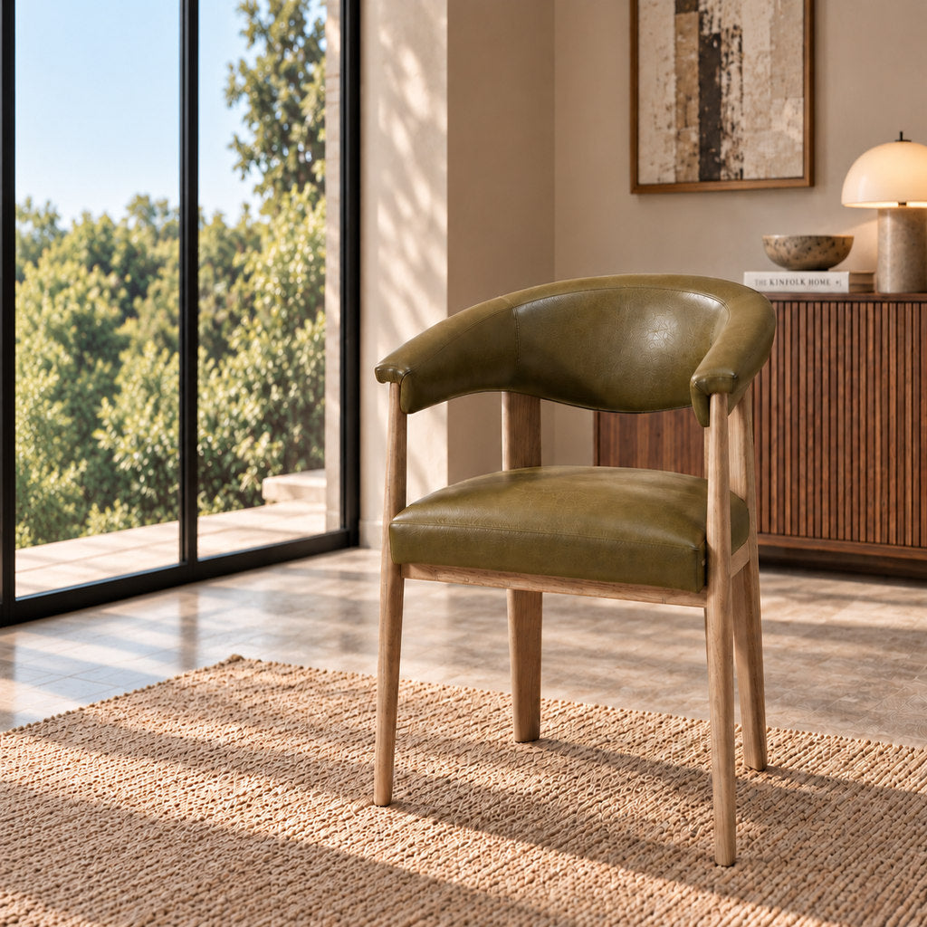 Stattera Sage Armchair in Jeep Green, featuring olive leather upholstery, a curved backrest, and light natural wood legs.