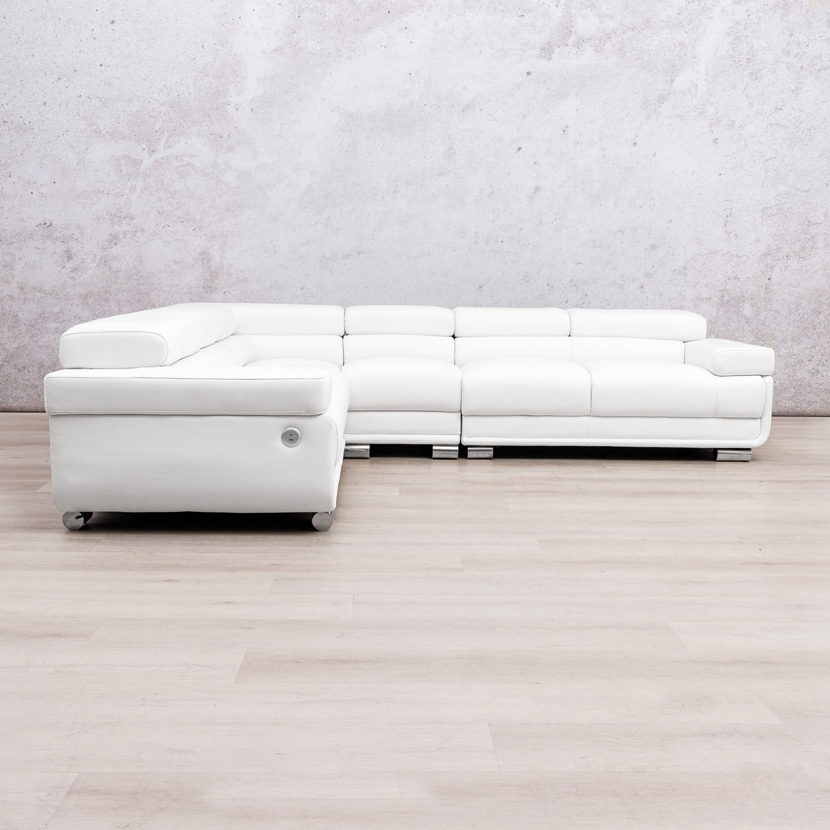 Leather Gallery Tobago 5 Seater L Shape sectional sofa in white leather with a left-facing chaise, against a light grey wall and wood flooring.