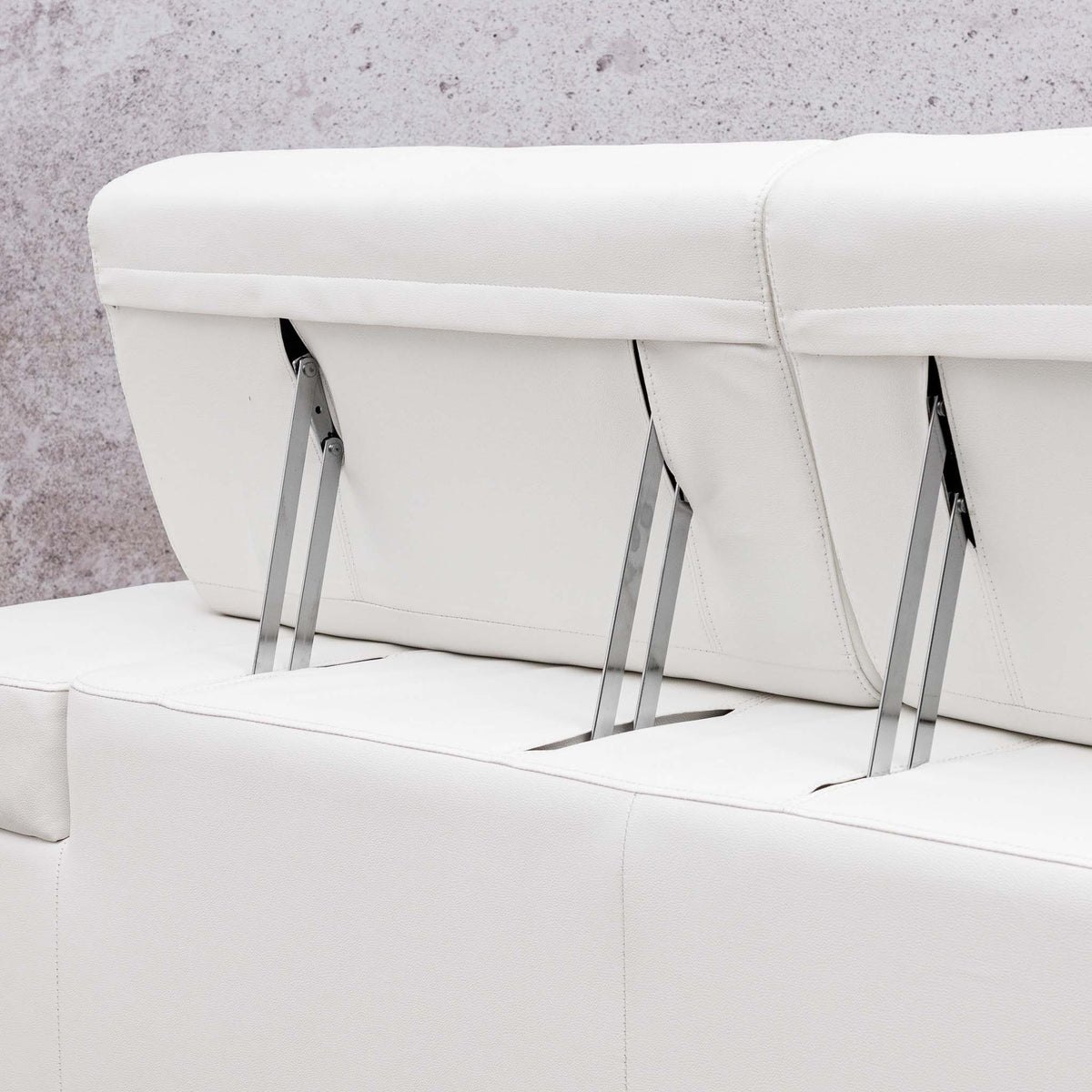 Close-up of the Leather Gallery Tobago 5 Seater L Shape Sectional in white, showing clean stitching and visible metal support legs.