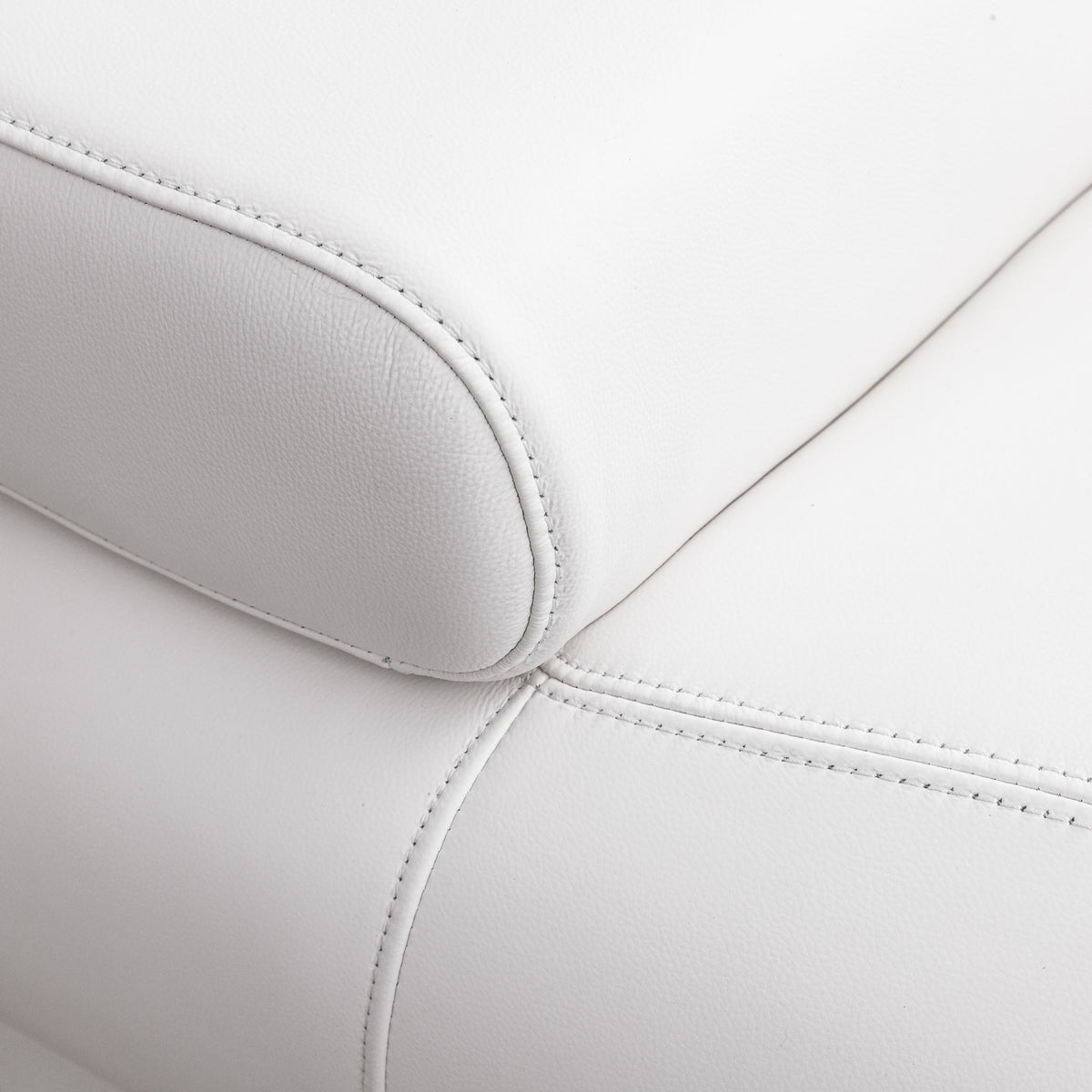 Close-up of the Leather Gallery Tobago 5 Seater L Shape Sectional in white, showing the textured leather armrest, seat corner, and precise stitching.