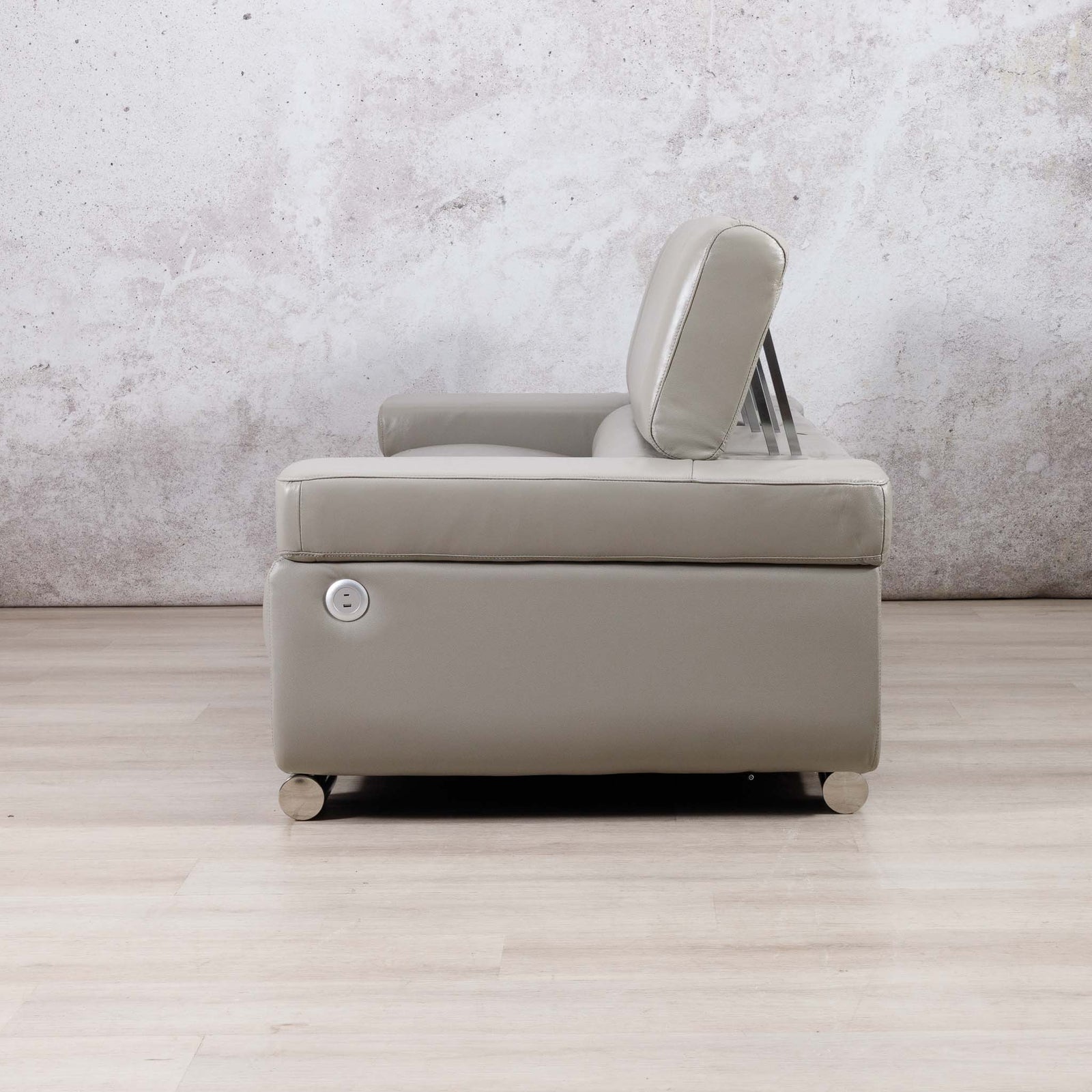 Side view of the Leather Gallery Tobago 3 Seater Leather Couch in Grey, showing the high backrest and circular side control.