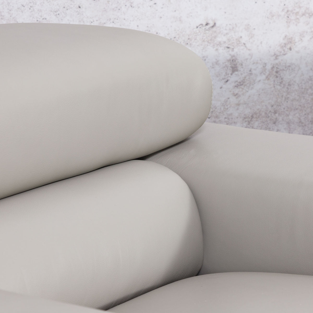 Close-up of the Leather Gallery Tobago 3 Seater Leather Couch in Grey, showing the curved seat, backrest, and armrest in smooth leather upholstery.