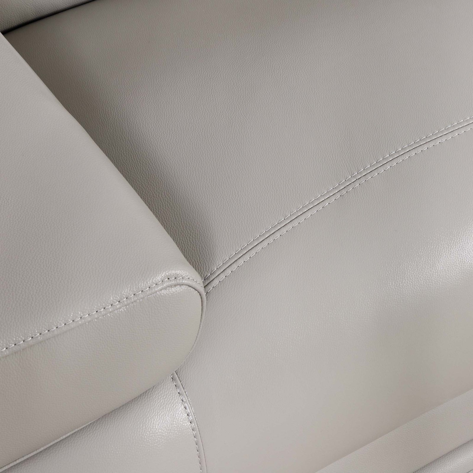 Close-up of the Leather Gallery Tobago 3 Seater Leather Couch in Grey, showing pebbled leather texture, visible stitching, and rounded armrest edges.
