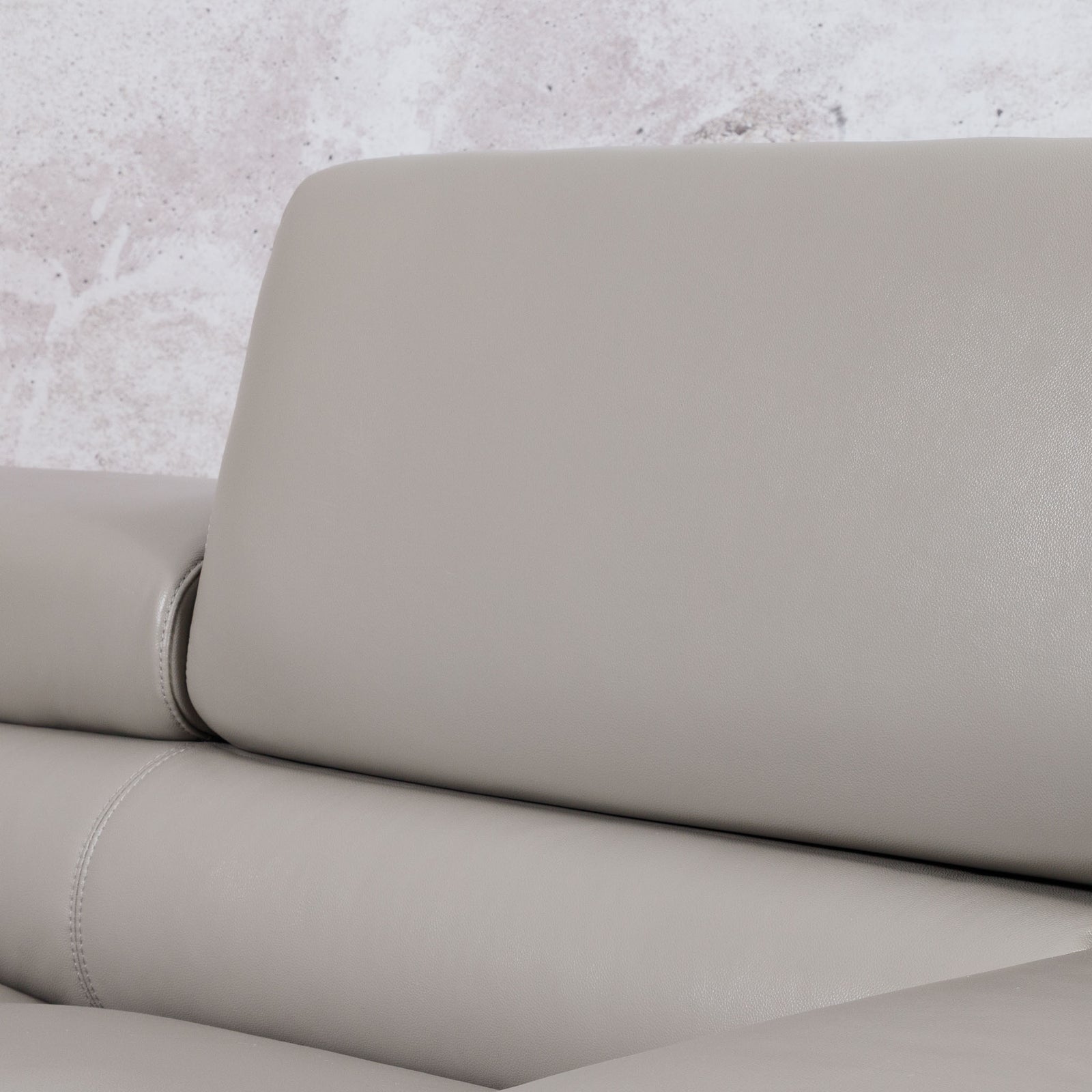 Close-up of the Leather Gallery Tobago 5 Seater Leather L Shape Couch in Grey, showing the backrest cushion, seat, and visible stitching detail.