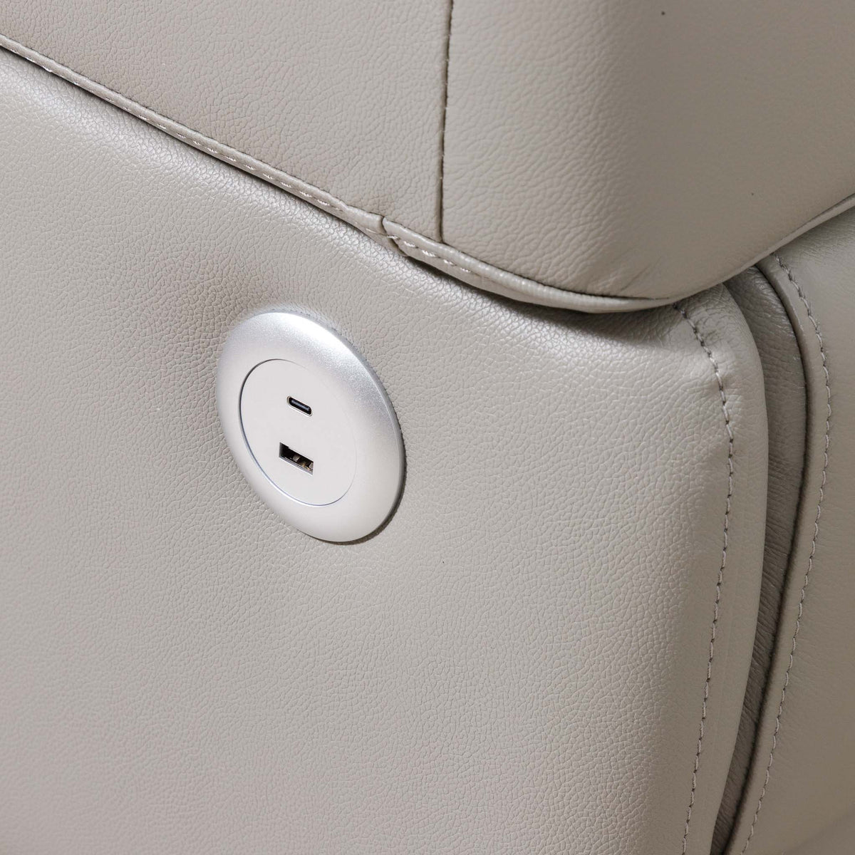 Close-up of the Leather Gallery Tobago 5 Seater Leather L Shape Couch in Grey, showing the circular silver USB charging outlet.