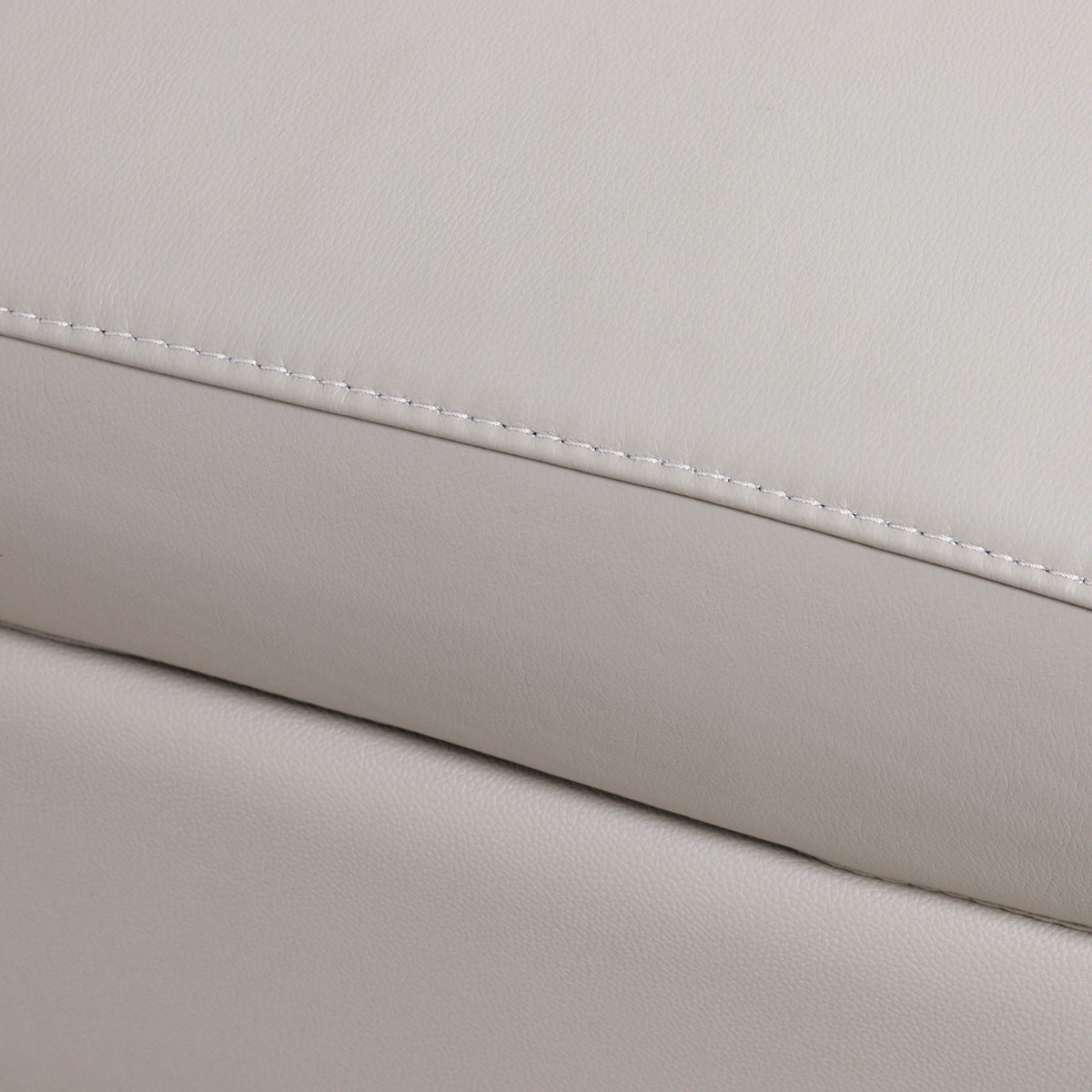 Close-up of the Leather Gallery Tobago 5 Seater Leather L Shape Couch in Grey, showing the stitched seam and rounded rectangular accent panel.