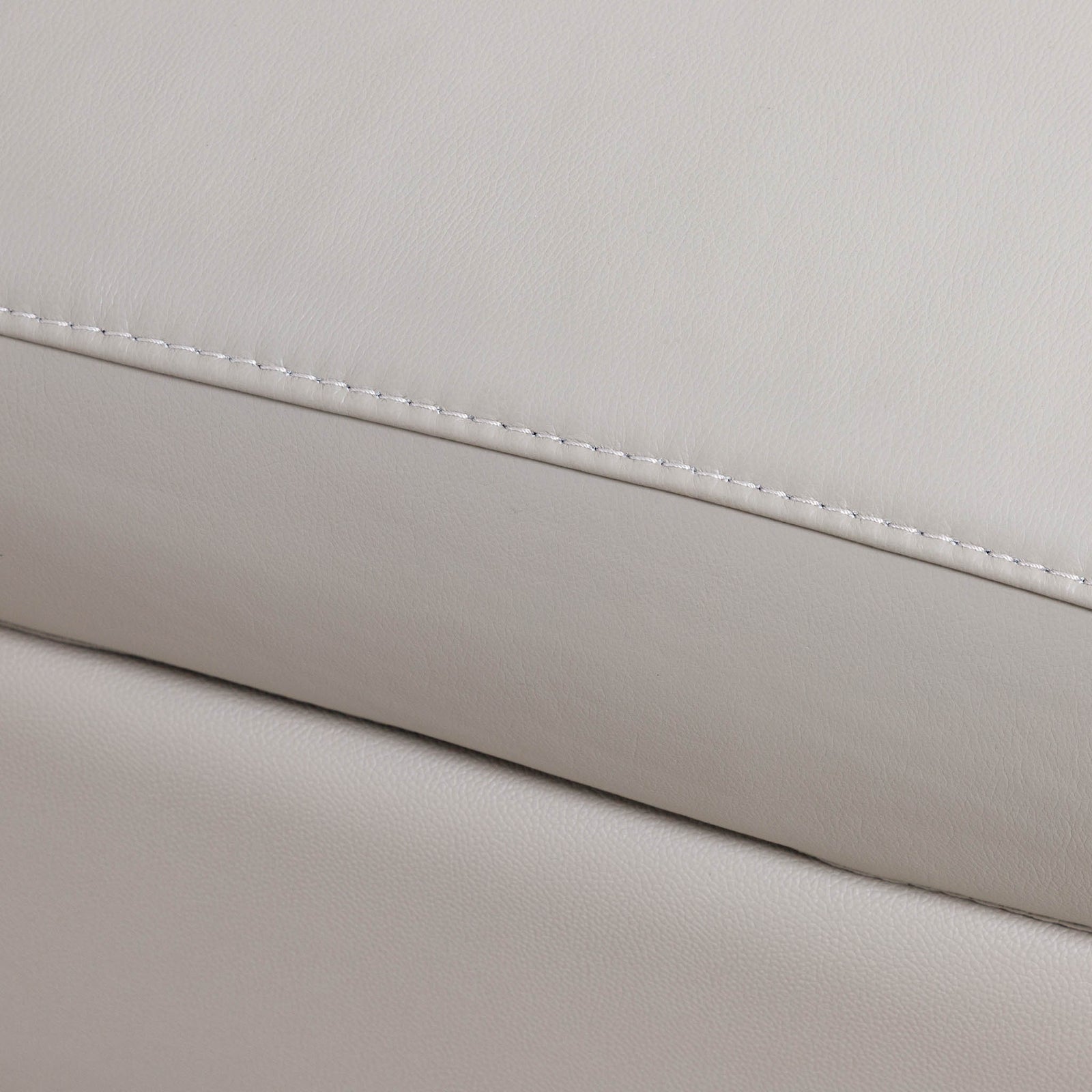 Close-up of the Leather Gallery Tobago 5 Seater Leather L Shape Couch in Grey, showing the stitched seam and rounded rectangular accent panel.