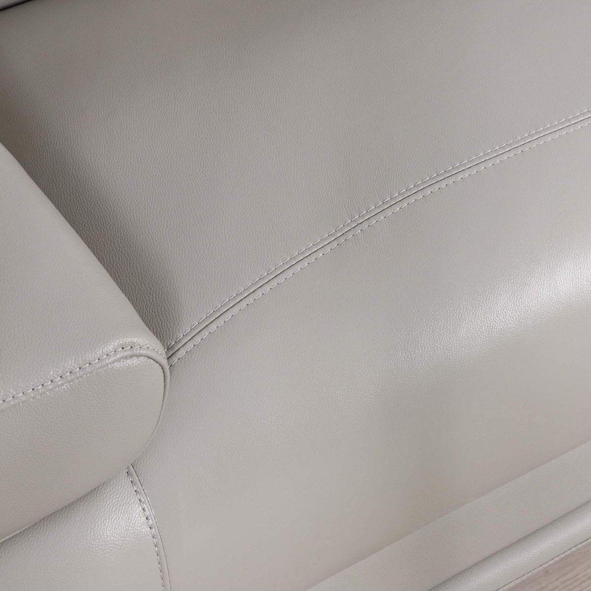 Close-up of the Leather Gallery Tobago 5 Seater Leather L Shape Couch in Grey, showing the leather texture, stitching, and armrest detail.