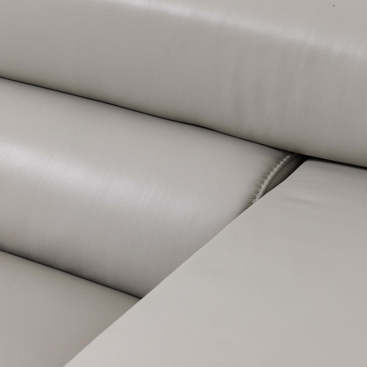 Close-up of the Leather Gallery Tobago 5 Seater Leather L Shape Couch in Grey, showing padded seat and back cushions with stitched seams.