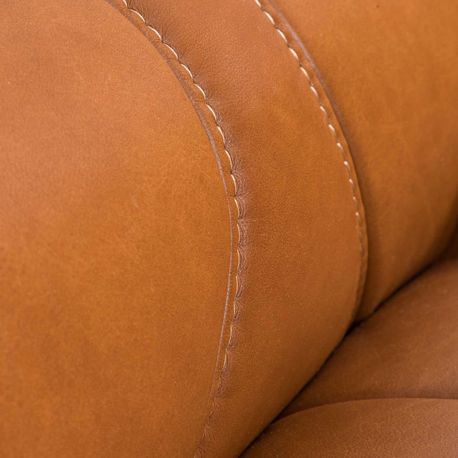 Close-up of the Leather Gallery Zuri 1 Seater Leather Couch in Czar Pecan, showing the leather texture and curved stitched seam.