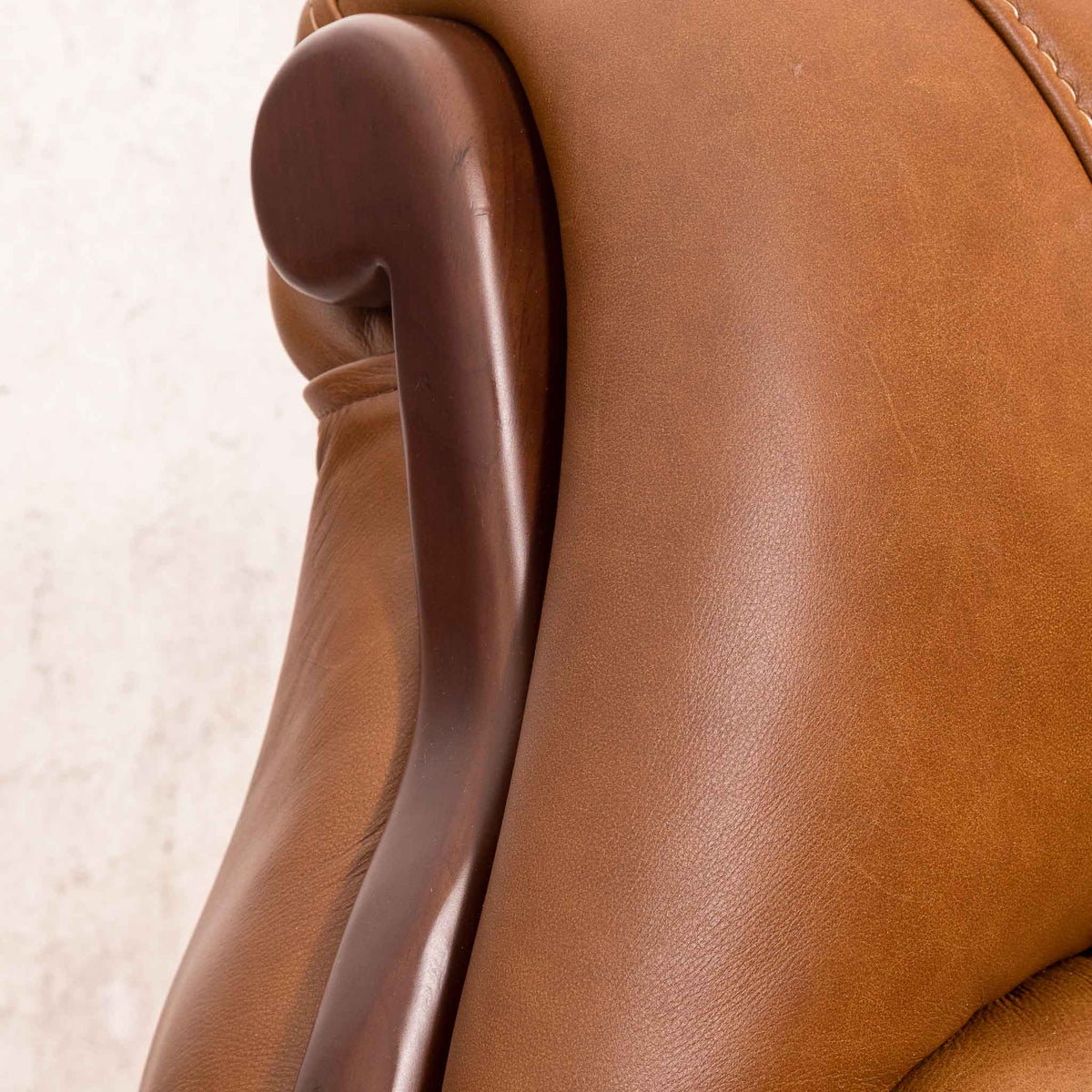 Close-up of the Leather Gallery Zuri 1 Seater Leather Couch in Czar Pecan, showing smooth leather upholstery and the dark wooden armrest.