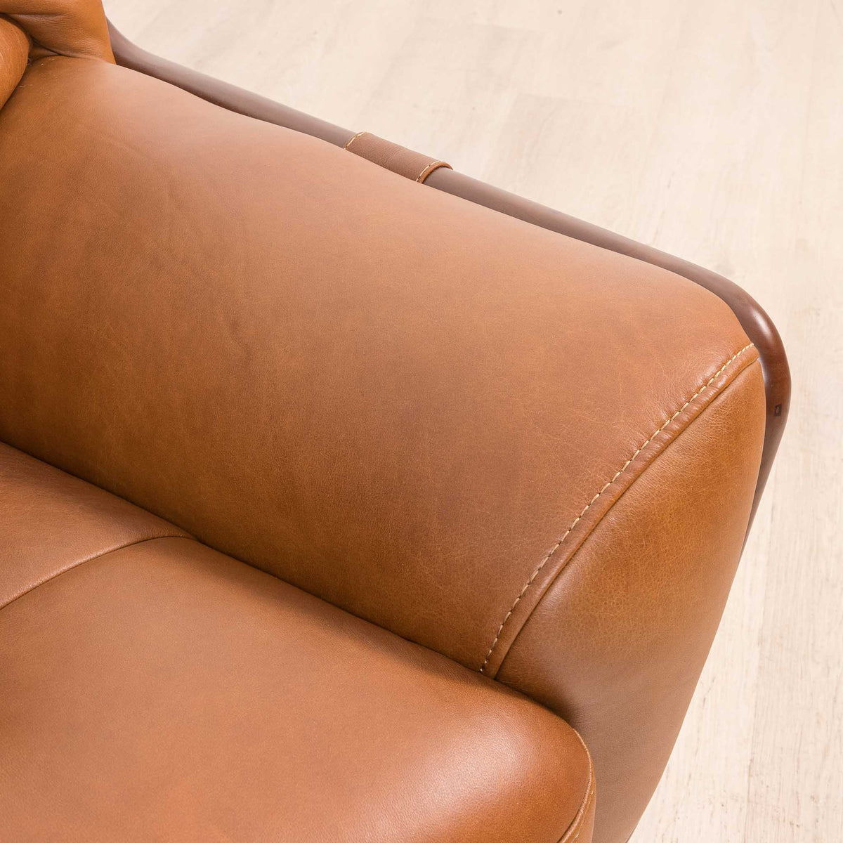 Close-up of the Leather Gallery Zuri 1 Seater Leather Couch in Czar Pecan, showing the rounded armrest and visible stitching detail.