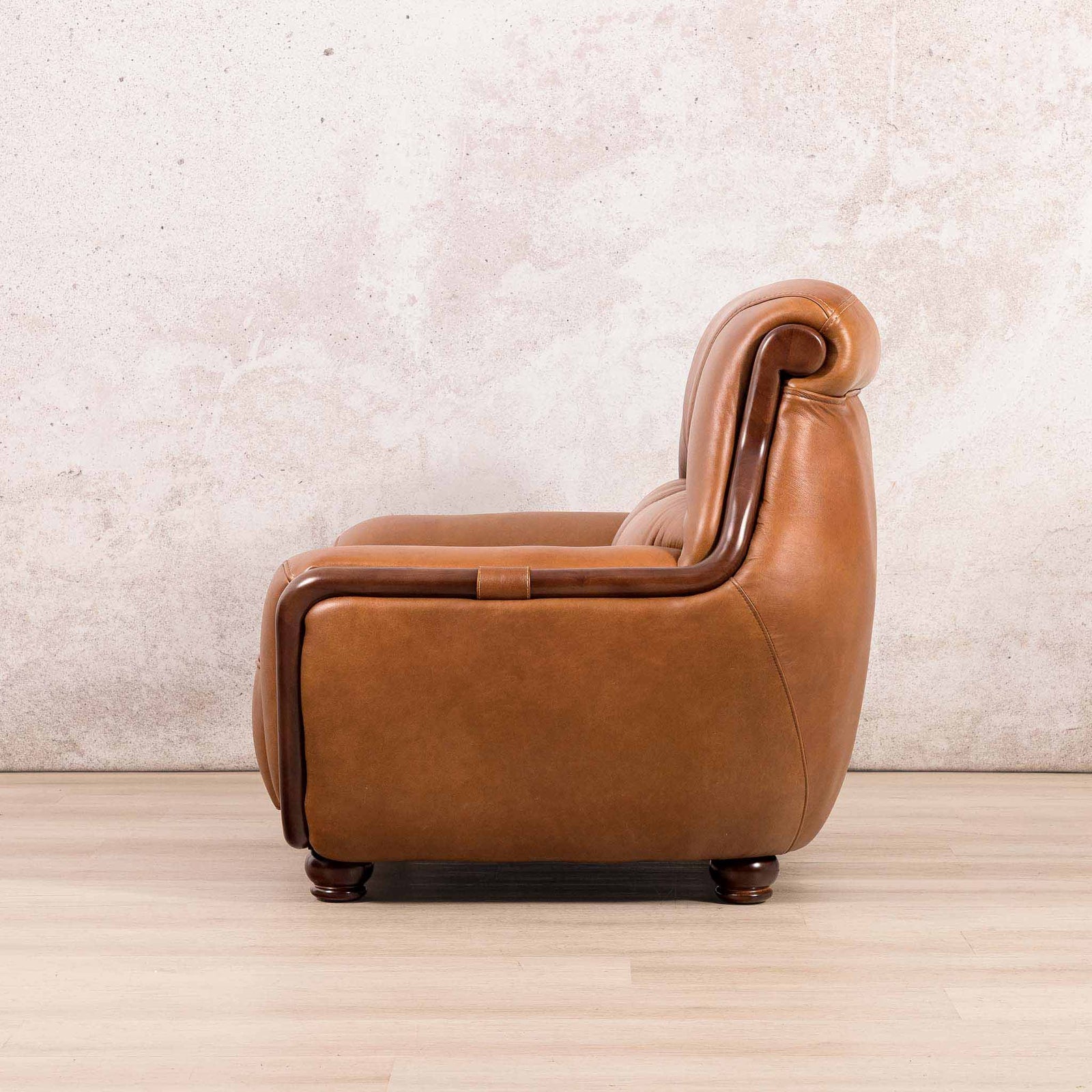 Side view of the Leather Gallery Zuri 1 Seater Leather Couch in Czar Pecan, featuring dark wood trim and turned wooden feet.