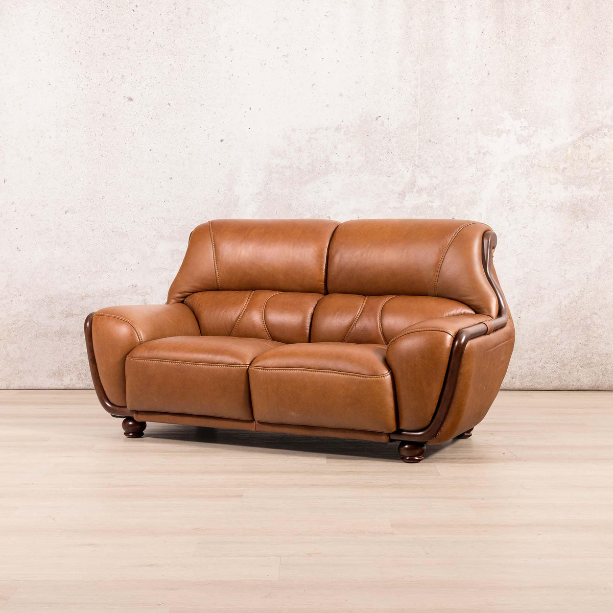 Leather Gallery Zuri 2 Seater Leather Couch in Czar Pecan, featuring dark wood trim and legs with warm leather upholstery.