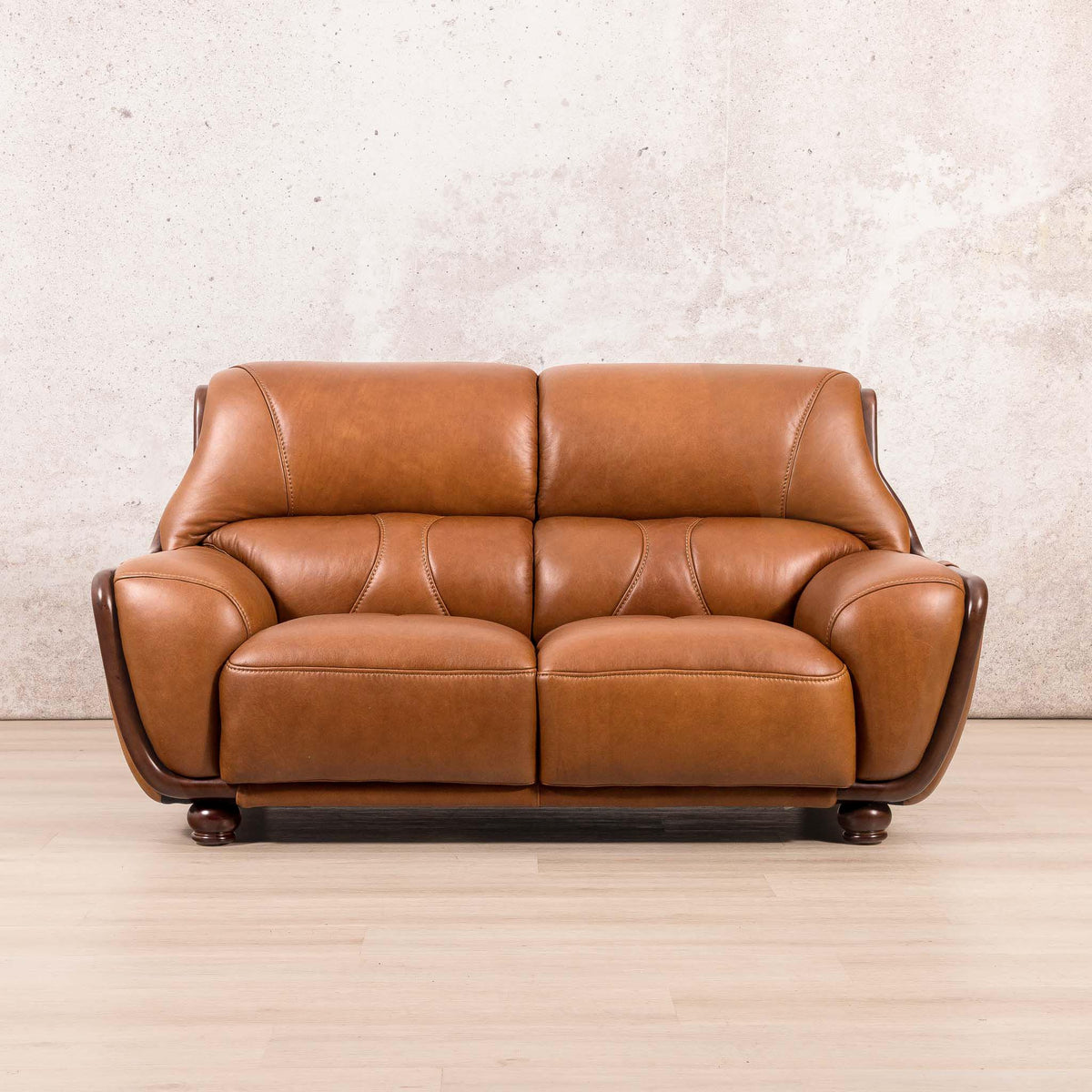 Leather Gallery Zuri 2 Seater Leather Couch in Czar Pecan, featuring dark wood arms and legs with warm leather upholstery.