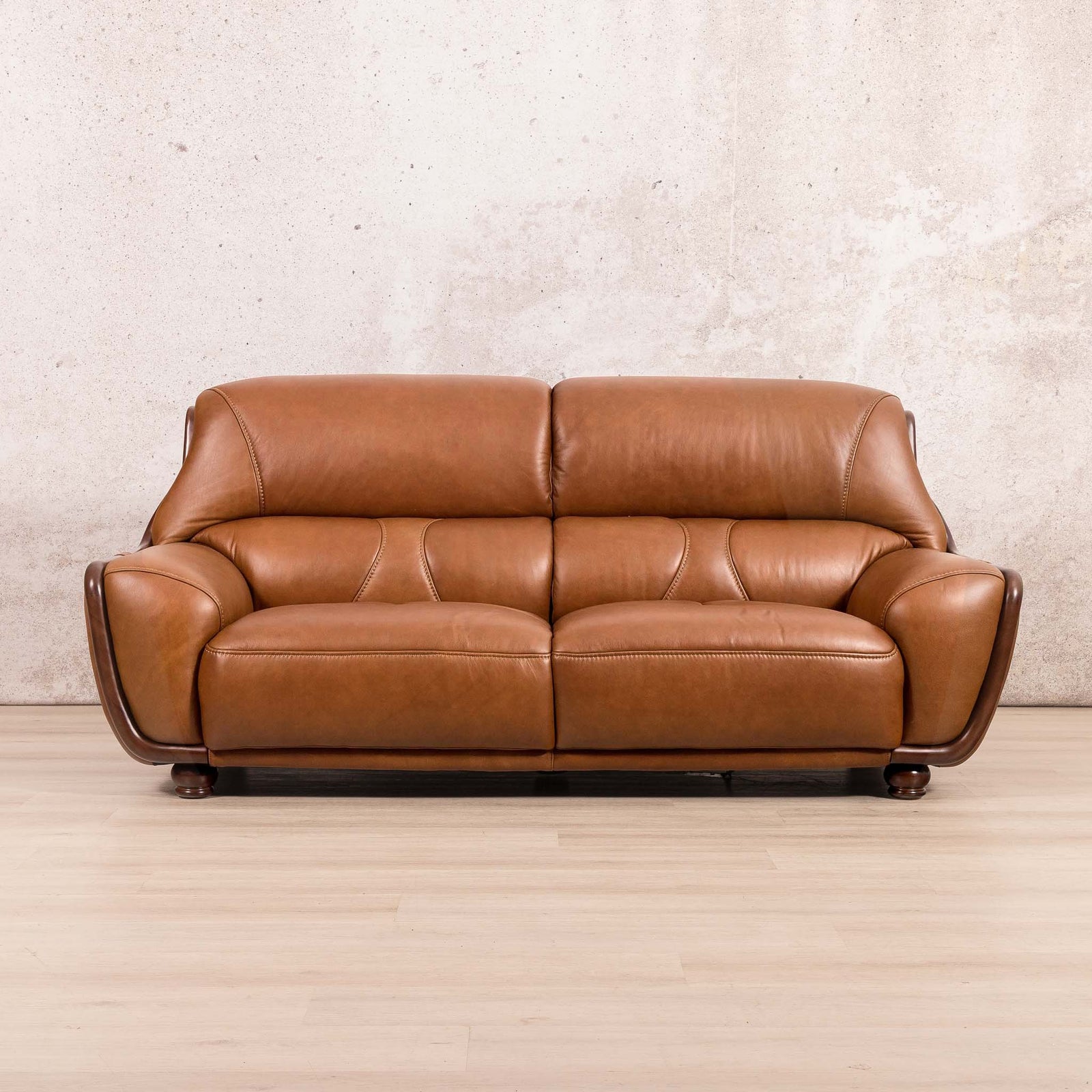 Leather Gallery Zuri 3 Seater Leather Couch in Czar Pecan, featuring tufted cushions and dark wooden legs.