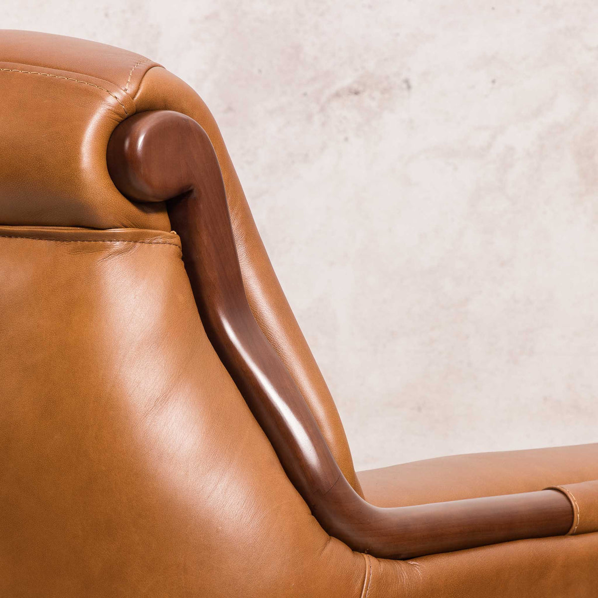 Close-up of the Leather Gallery Zuri 3 Seater Leather Couch in Czar Pecan, showing the rolled wooden armrest and smooth leather upholstery.