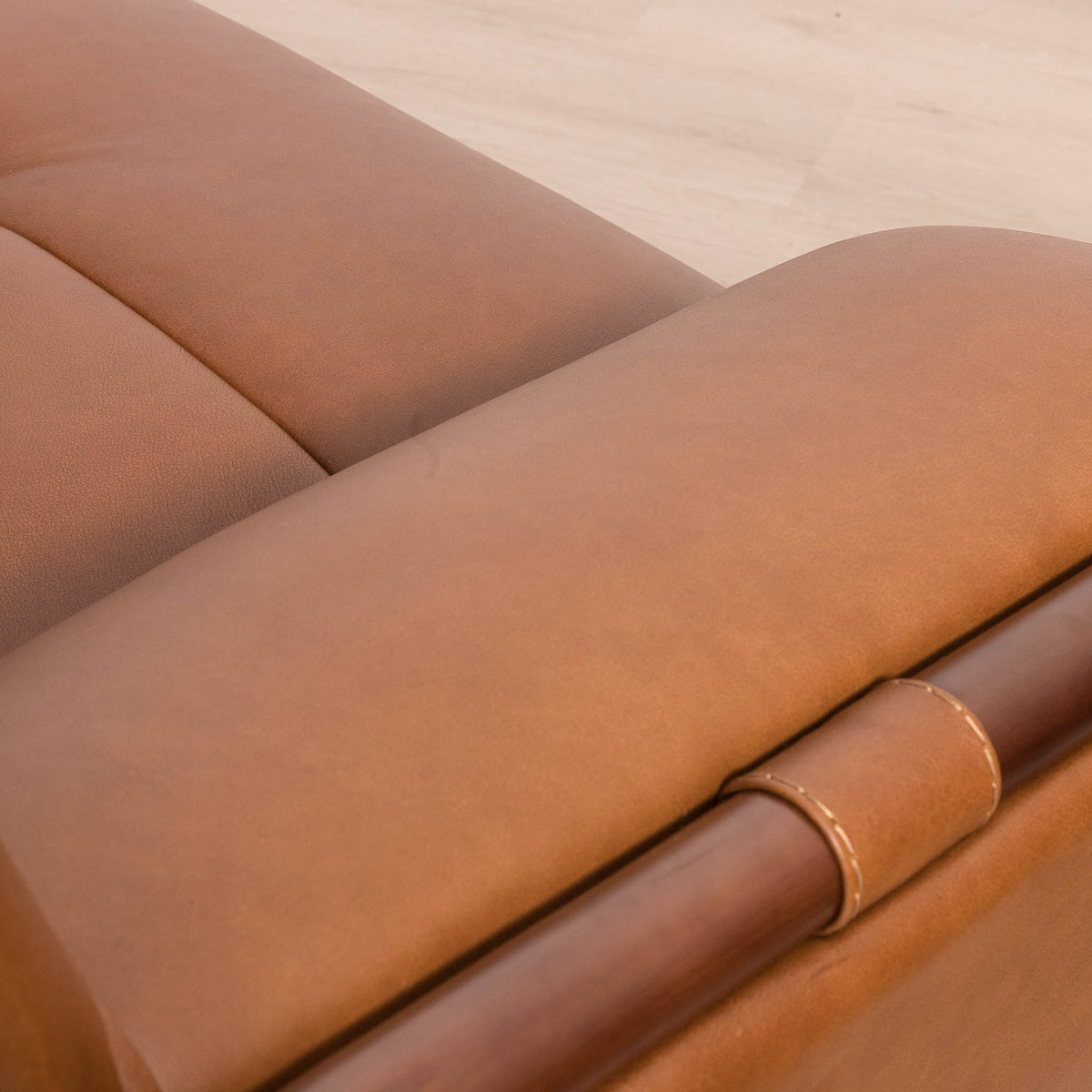 Close-up of the Leather Gallery Zuri 3 Seater Leather Couch in Czar Pecan, showing the leather cushion, dark wood frame, and visible stitching.