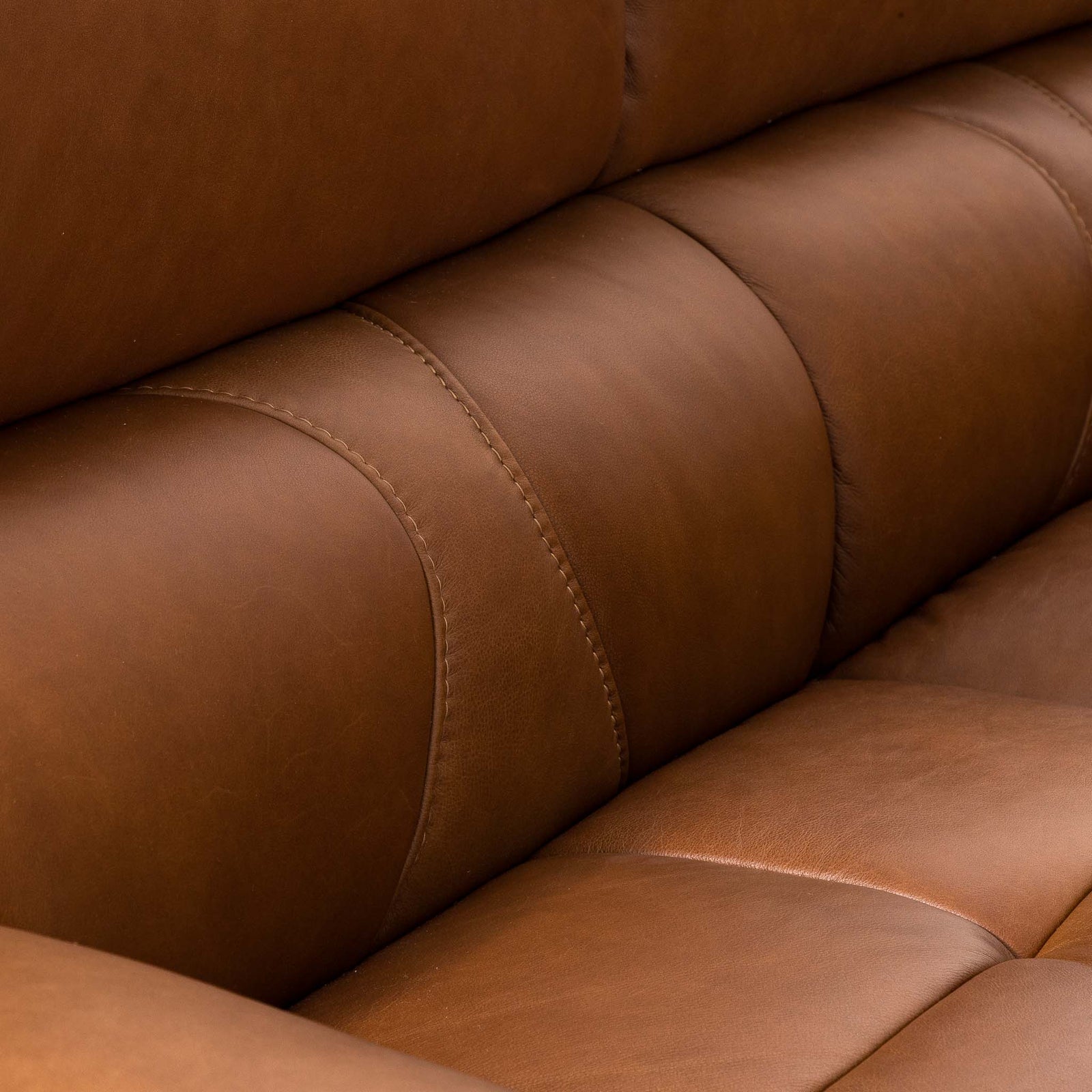 Close-up of the Leather Gallery Zuri 3 Seater Leather Couch in Czar Pecan, showing the tufted backrest, seat cushion, and matching stitching.
