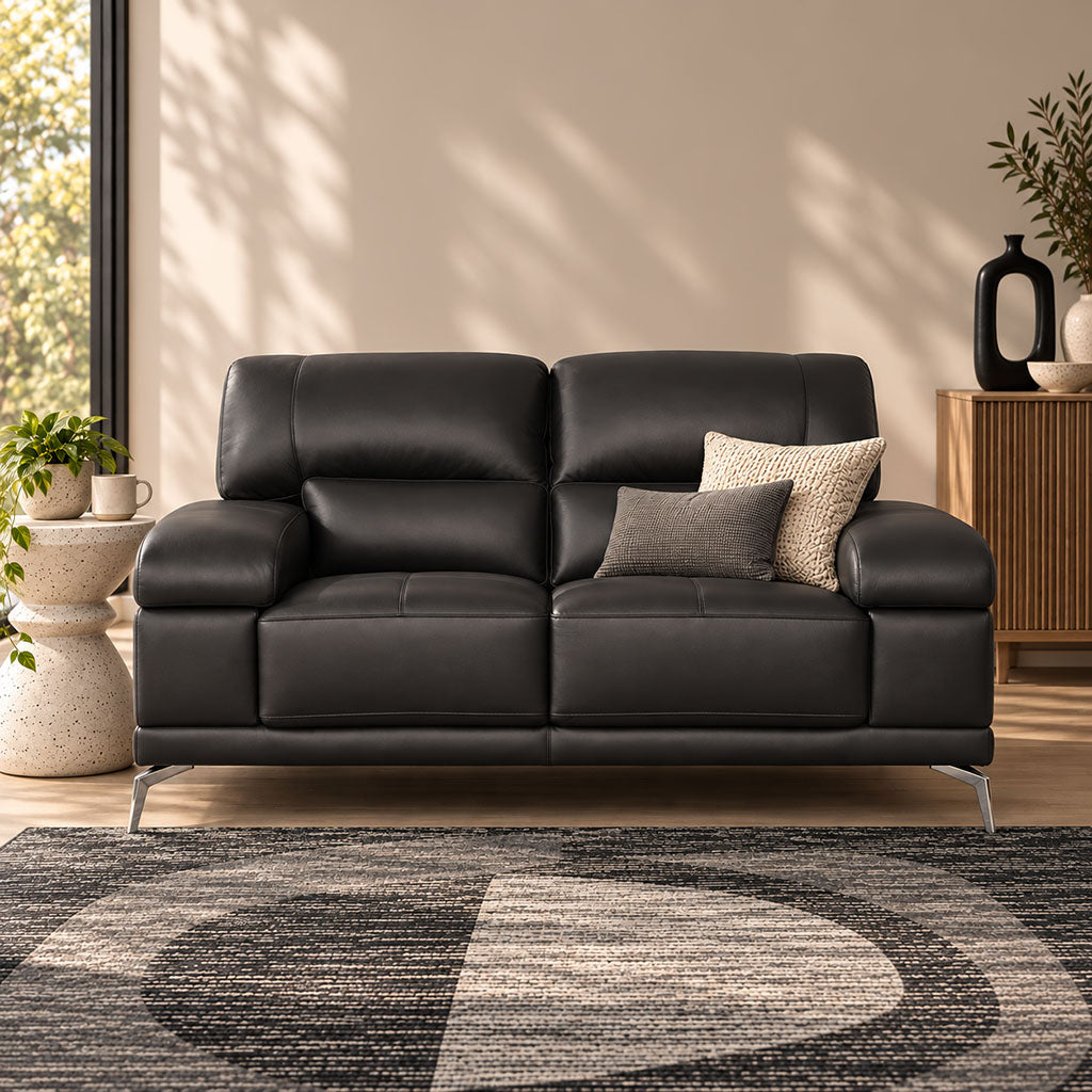 Leather Gallery Adaline 2 Seater Leather Couch in Luxe Black, featuring black leather upholstery and decorative cushions in a contemporary living room.