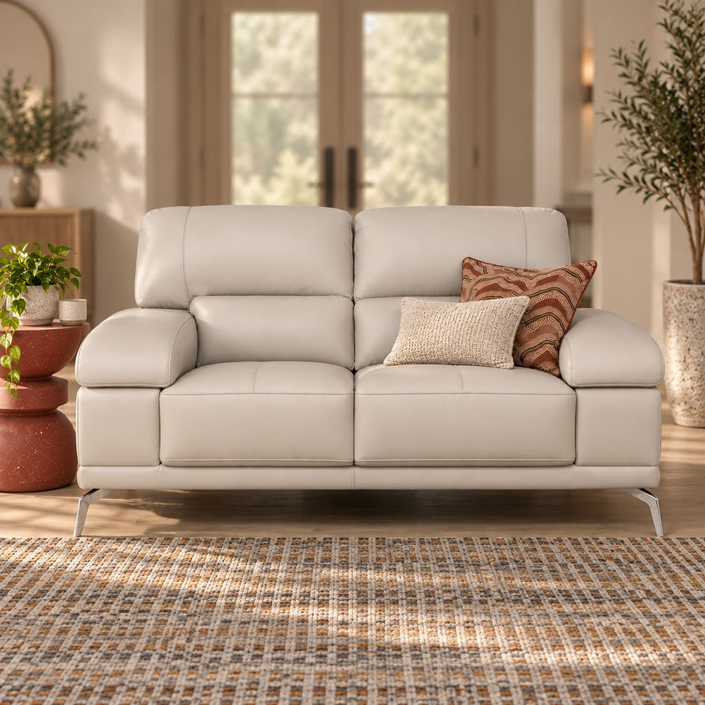 Leather Gallery Adaline 2 Seater Leather Couch in Luxe Grey, featuring light grey leather upholstery and decorative cushions in a bright modern living room.