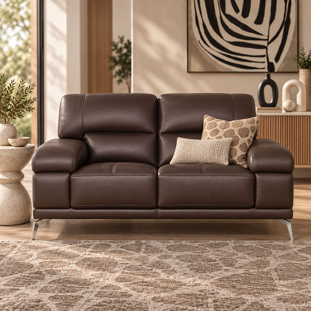 Leather Gallery Adaline 2 Seater Leather Couch in Luxe Walnut, featuring dark brown leather upholstery and decorative cushions in a warm modern living room.