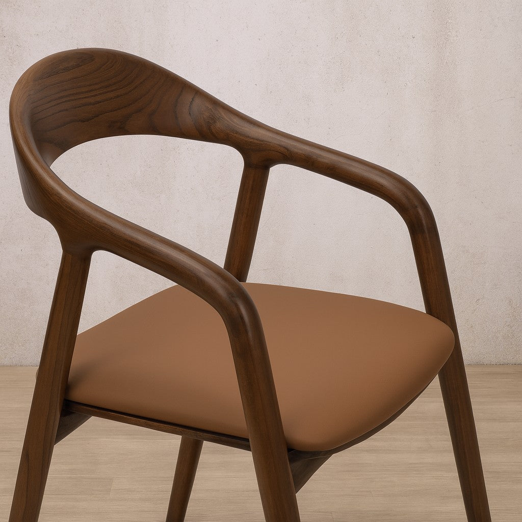 Alaric wooden dining chair with a curved backrest and brown leather cushioned seat, perfect for those seeking modern dining chairs with timeless appeal.
