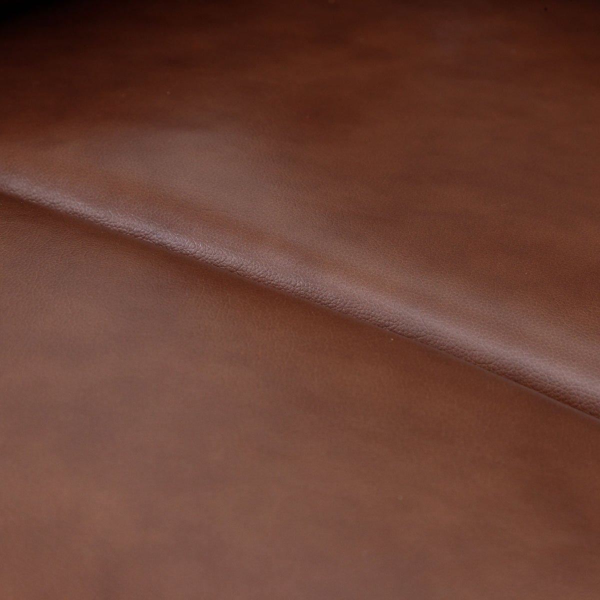 Close-up of the Leather Gallery Dallas Leather Rocker Recliner Chair in Saddle, showing the smooth leather texture and warm brown finish.