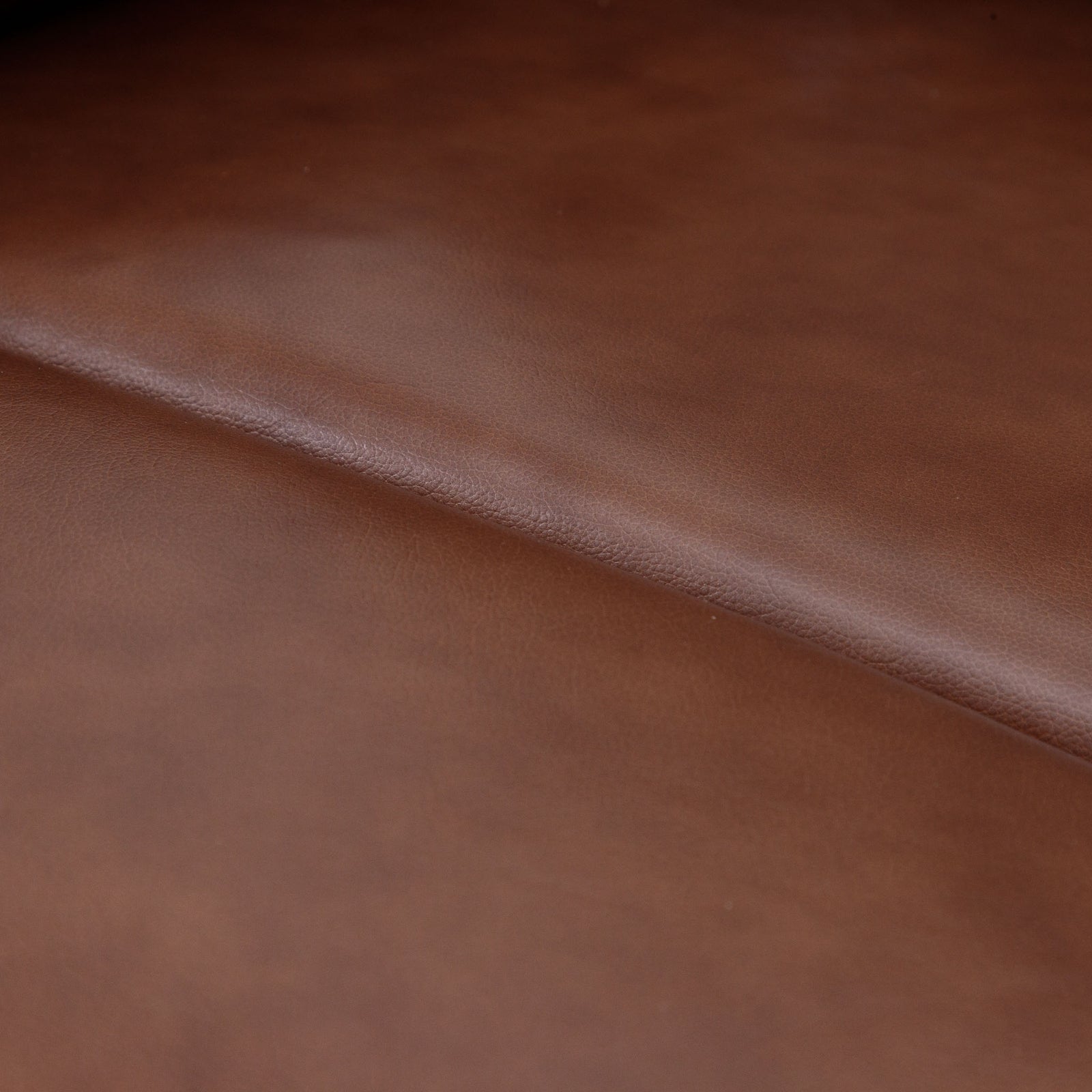 Close-up of the Leather Gallery Dallas Leather Rocker Recliner Chair in Saddle, showing the smooth leather texture and warm brown finish.
